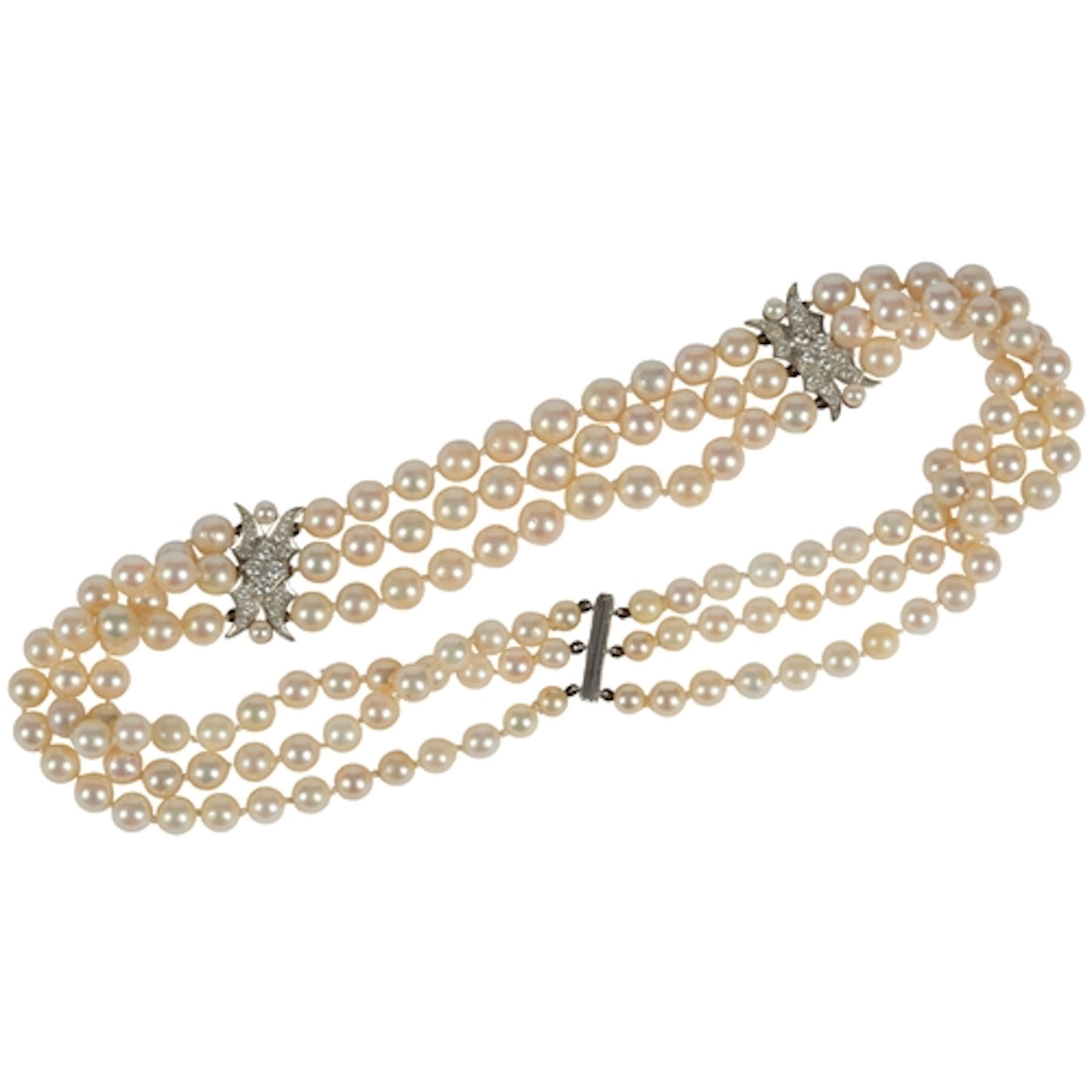 A cultured pearl and diamond necklace, composed of three row...