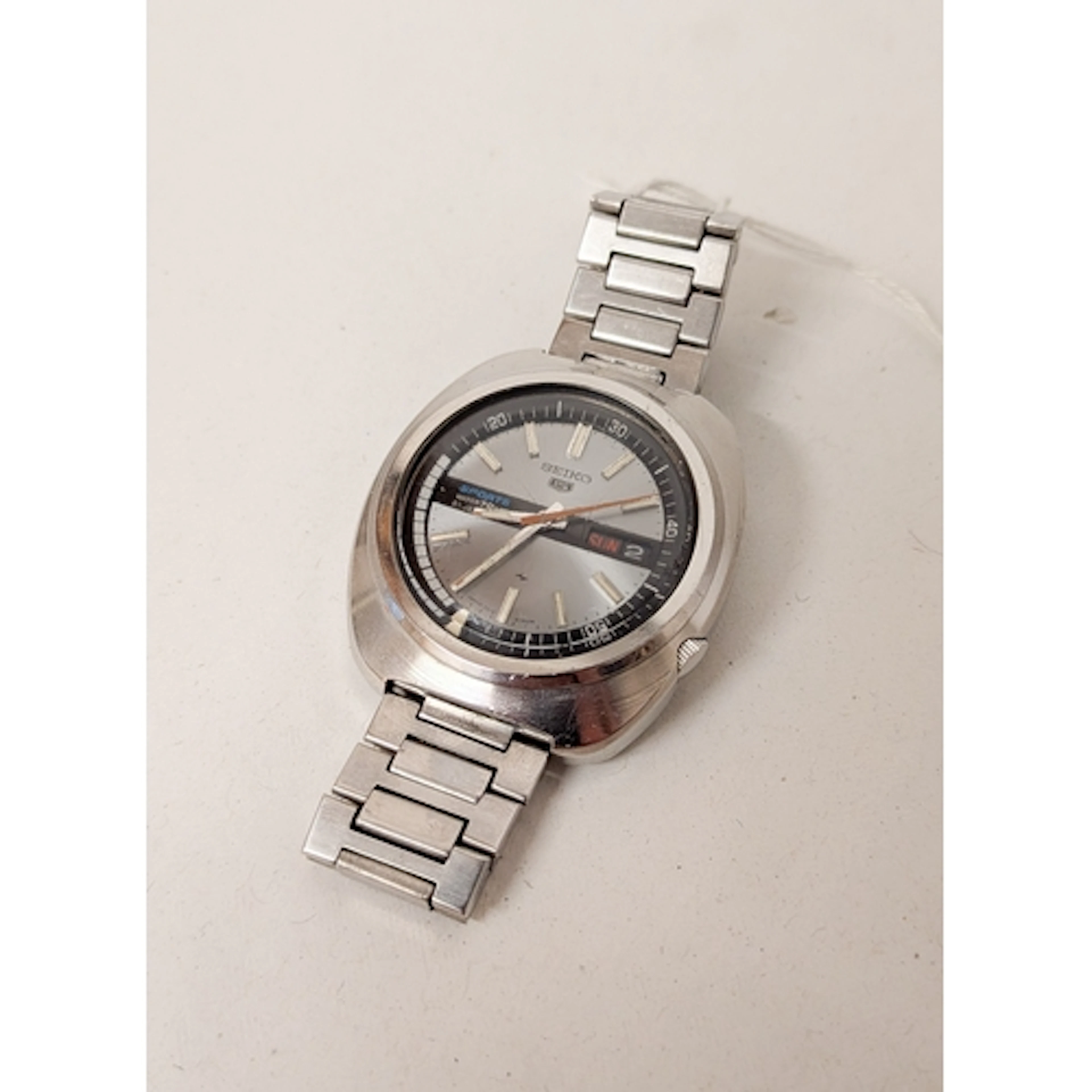 A vintage Seiko 5 Sports automatic calendar wristwatch on st...