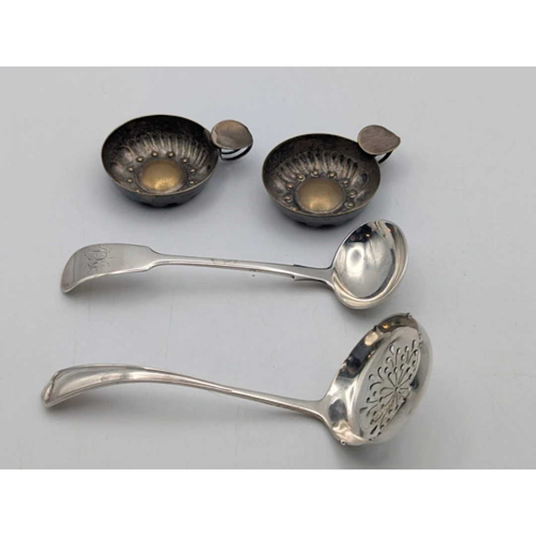 A silver sauce ladle and sugar sifter along with two silver ...
