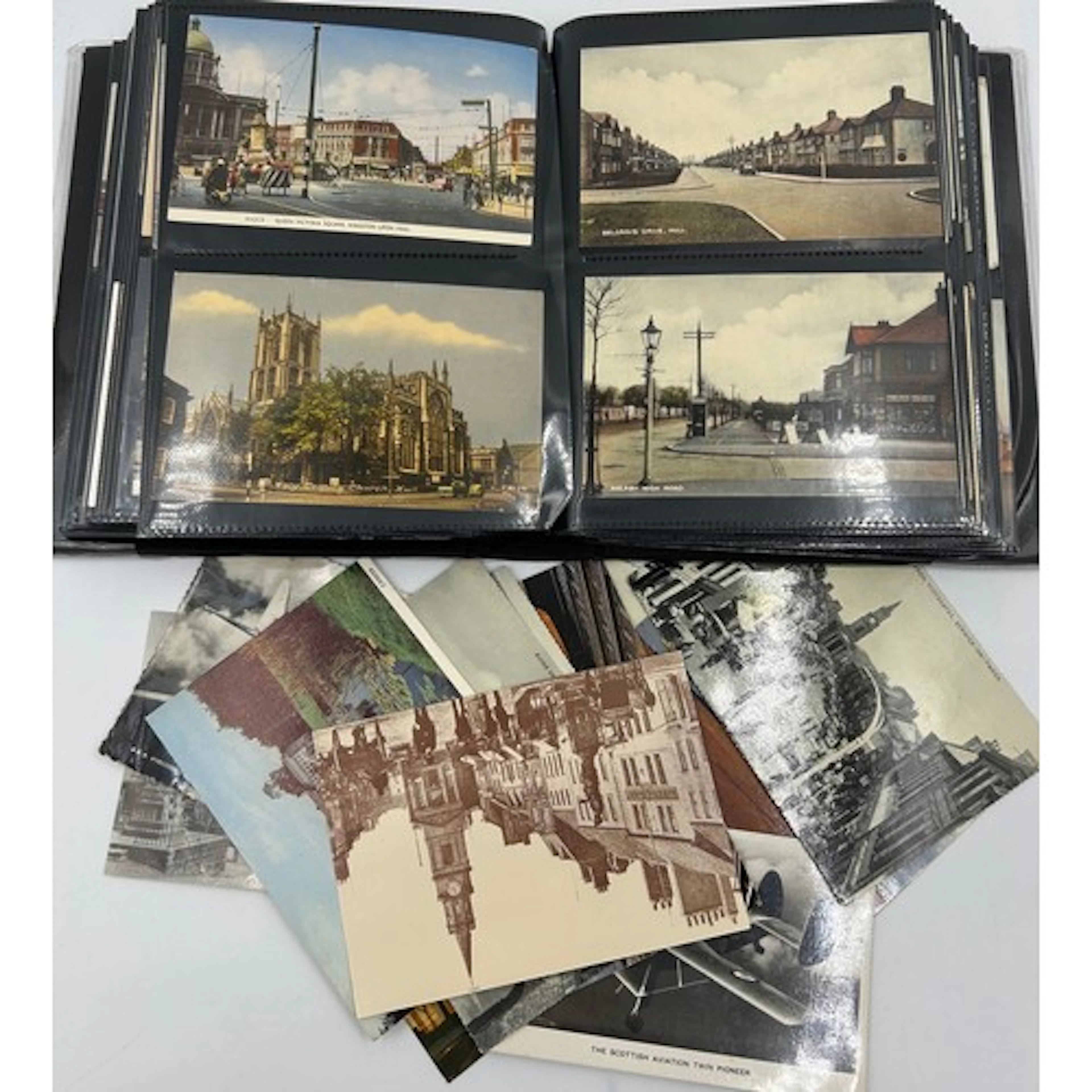 An album containing approximately 200 postcards, mixed ages ...