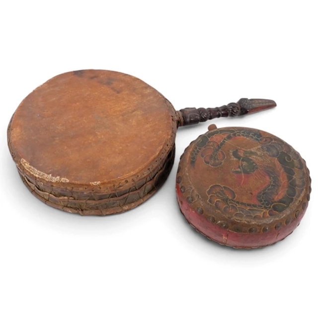 A South East Asian hand drum with carved wood handle, L61cm,...