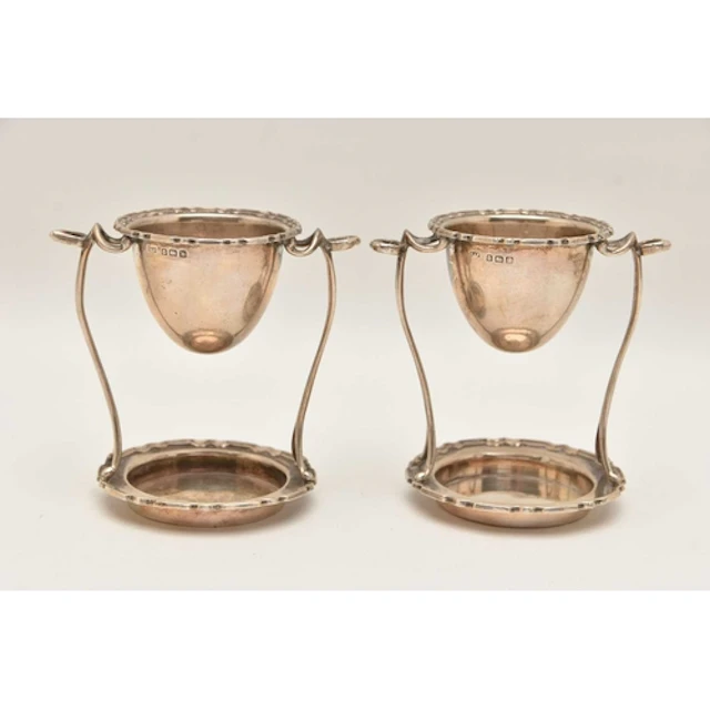 A PAIR OF EALRY 20TH CENTURY SILVER EGG CUP STANDS, both wit...