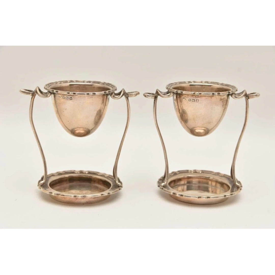 A PAIR OF EALRY 20TH CENTURY SILVER EGG CUP STANDS, both wit...
