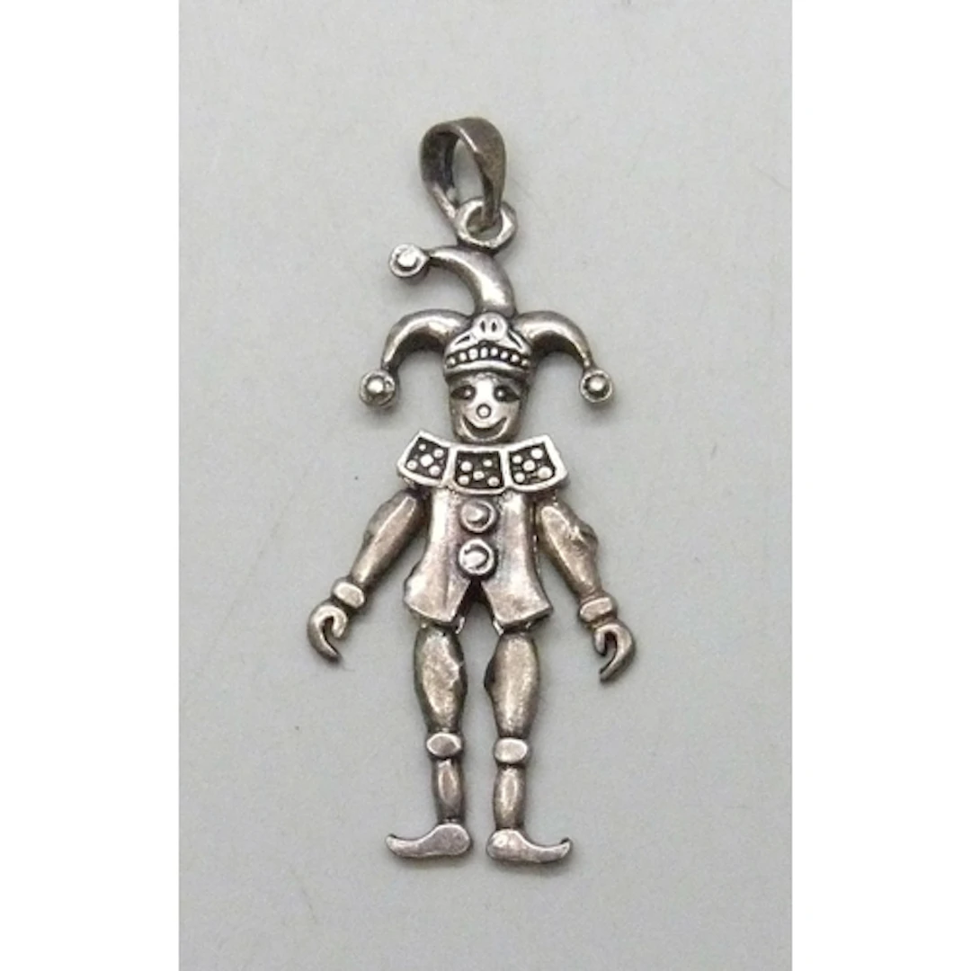 A silver articulated necklace pendant in the form of a jeste...