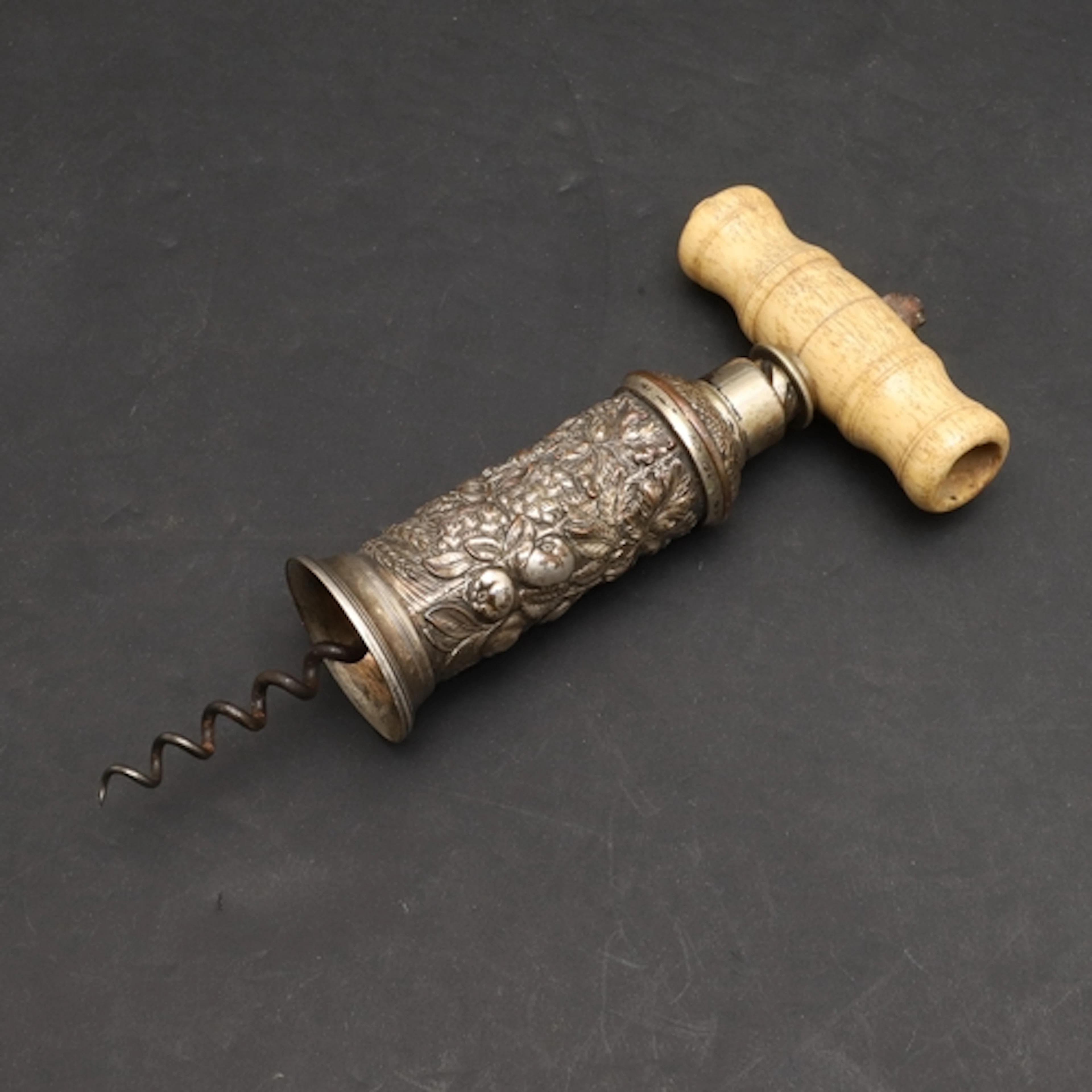 A GEORGE III SILVER PLATED AND BONE HANDLED CORKSCREW. The t...