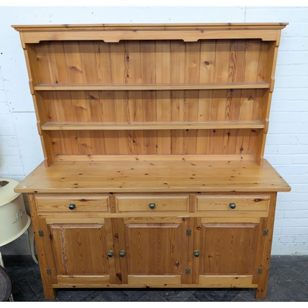 A modern varnished pine shelf back dresser, 63" wide