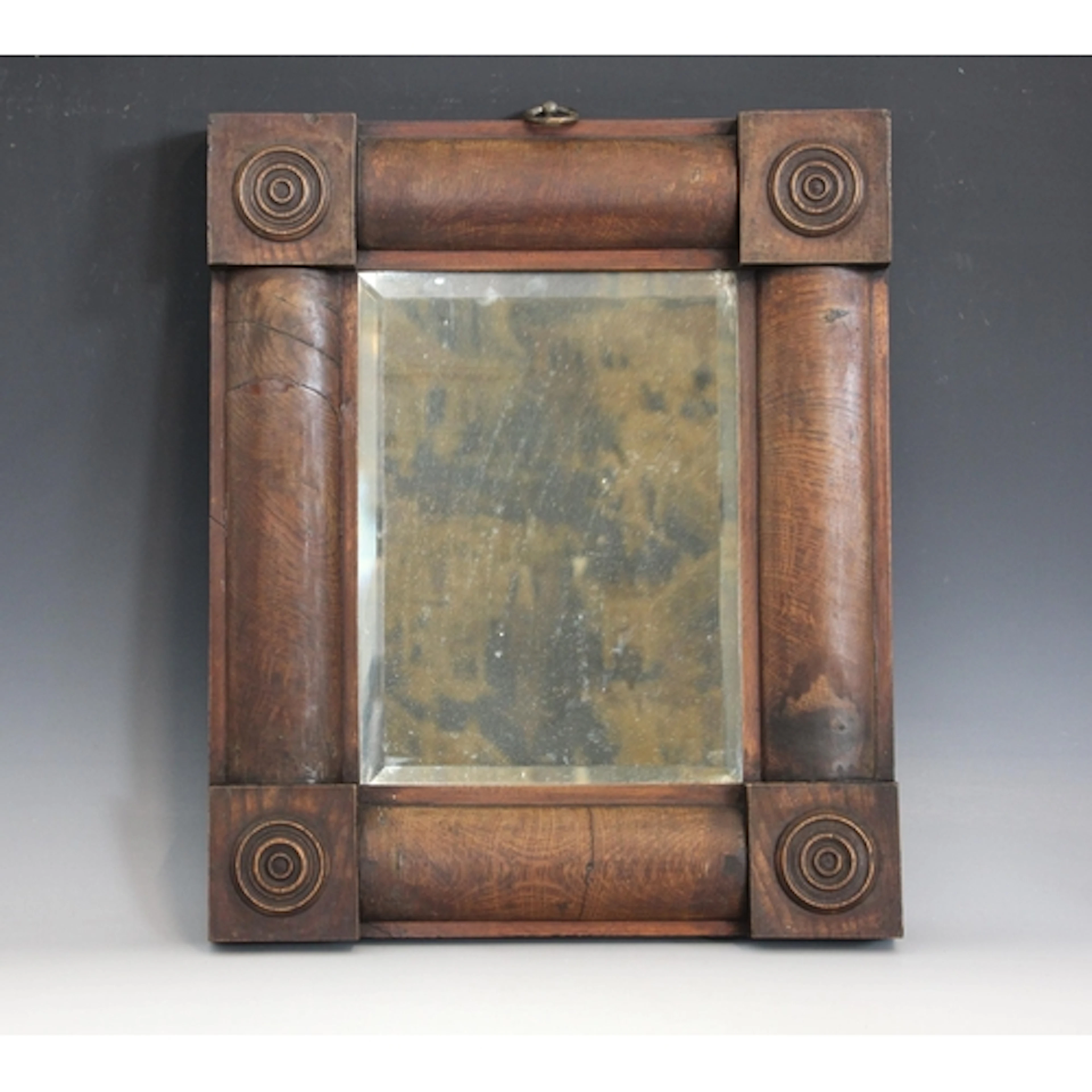 A William IV oak wall mirror, the bevelled mirrored plate of...