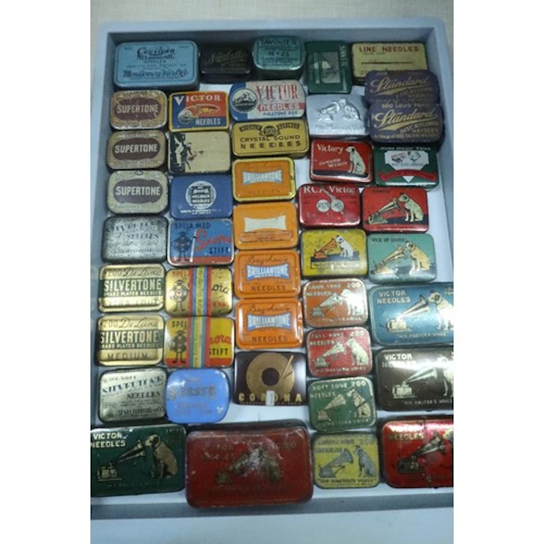A tray of vintage gramophone needle tins