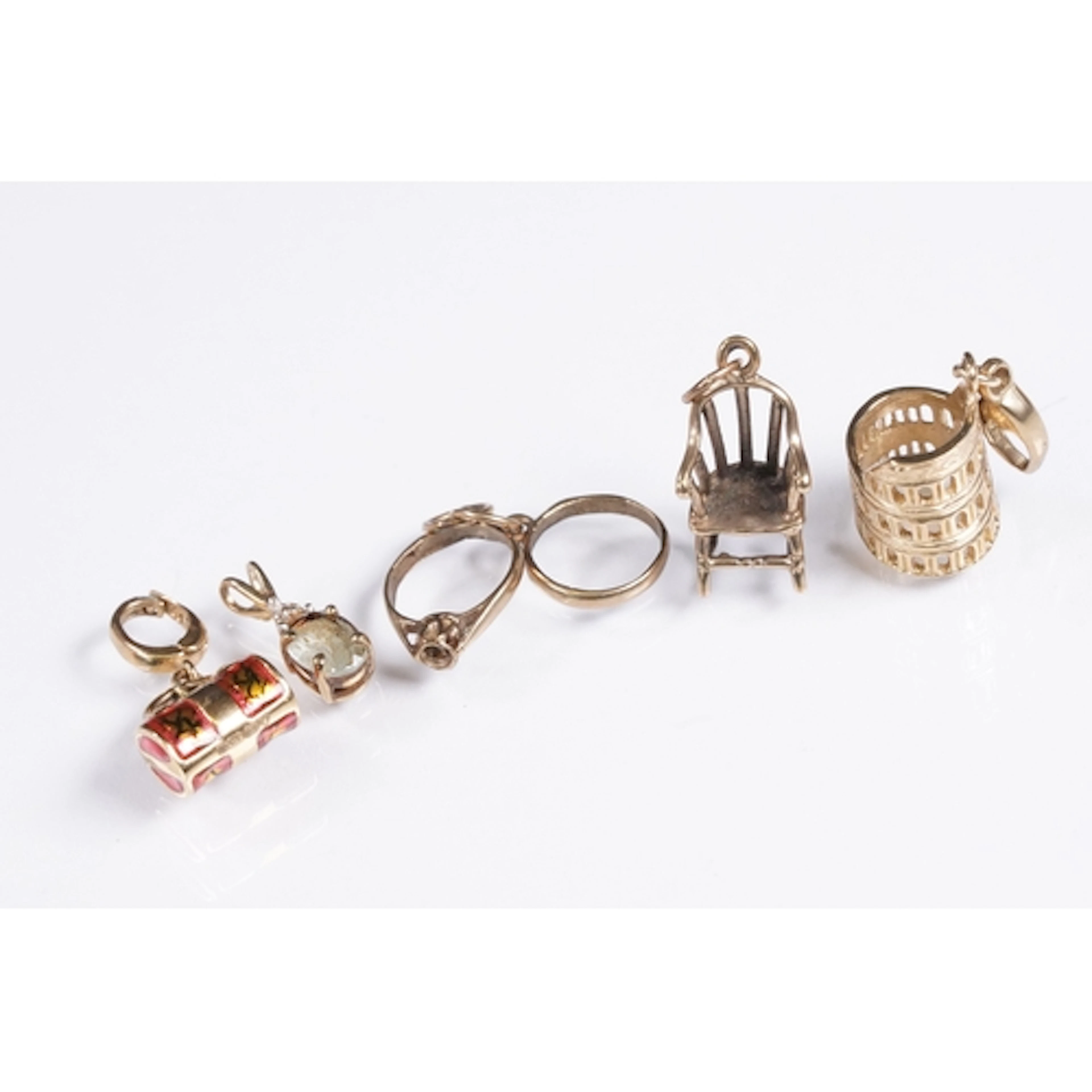 Group of 9ct gold pendants and charms to include the colosse...