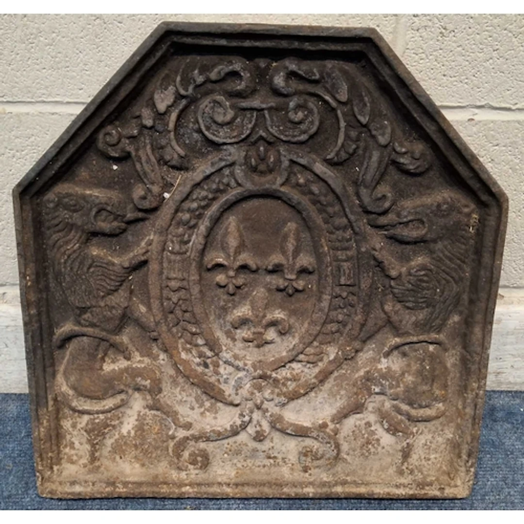 A CAST IRON FIRE BACK, depicting a French coat of arms, with...