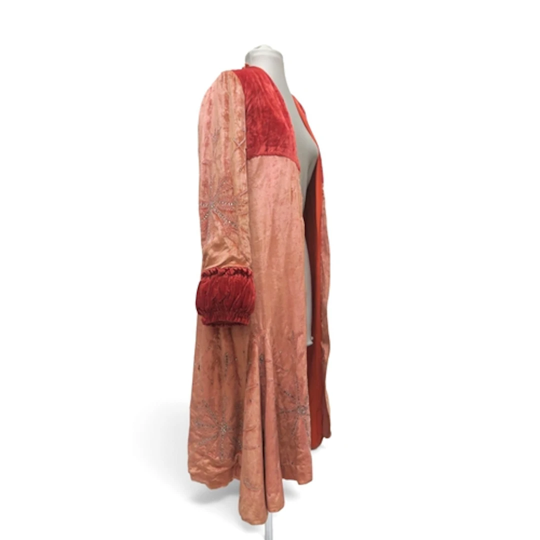 A pink velvet opera coat embroidered with beads and rhinesto...