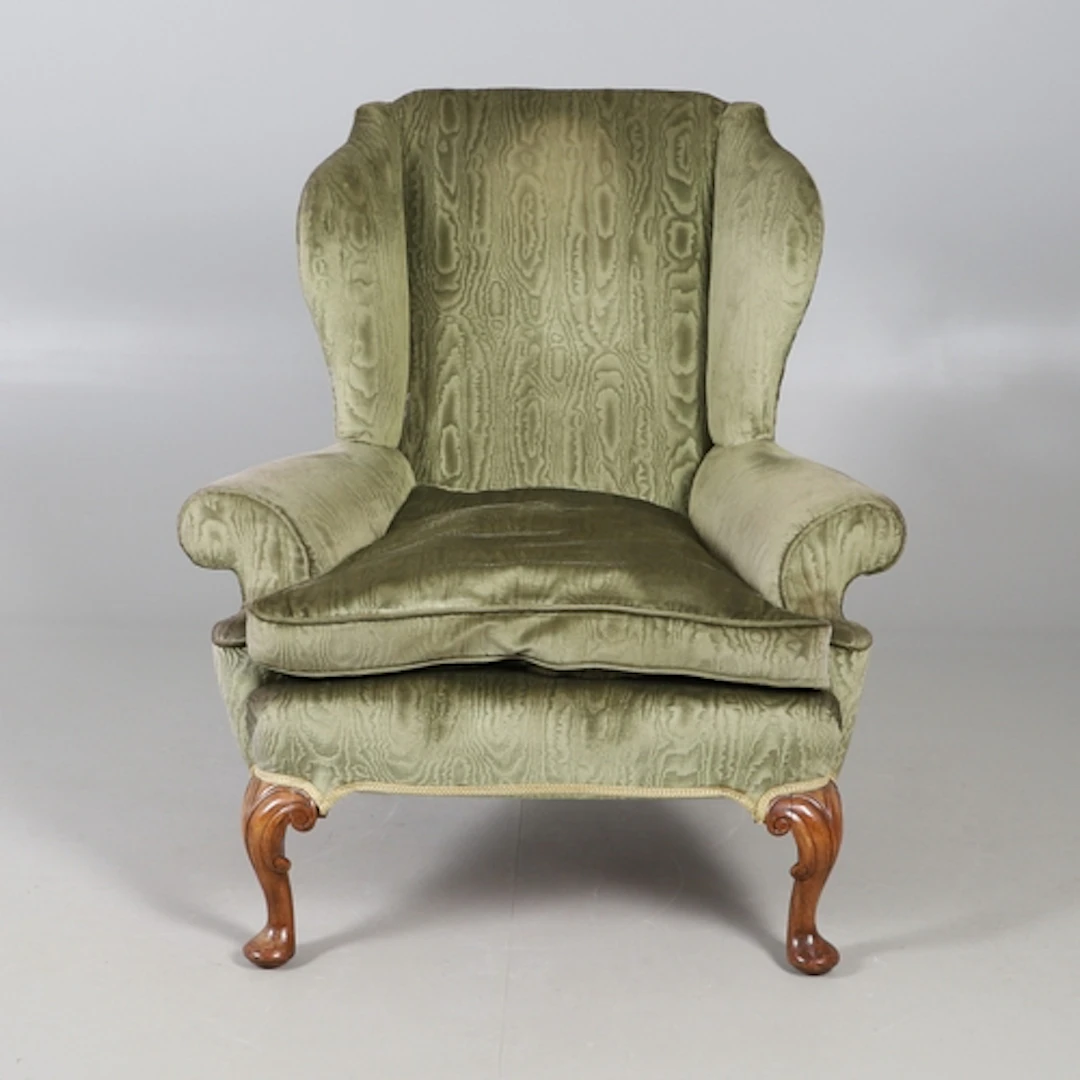 A QUEEN ANNE STYLE WALNUT ARMCHAIR. the flattened scrolling ...