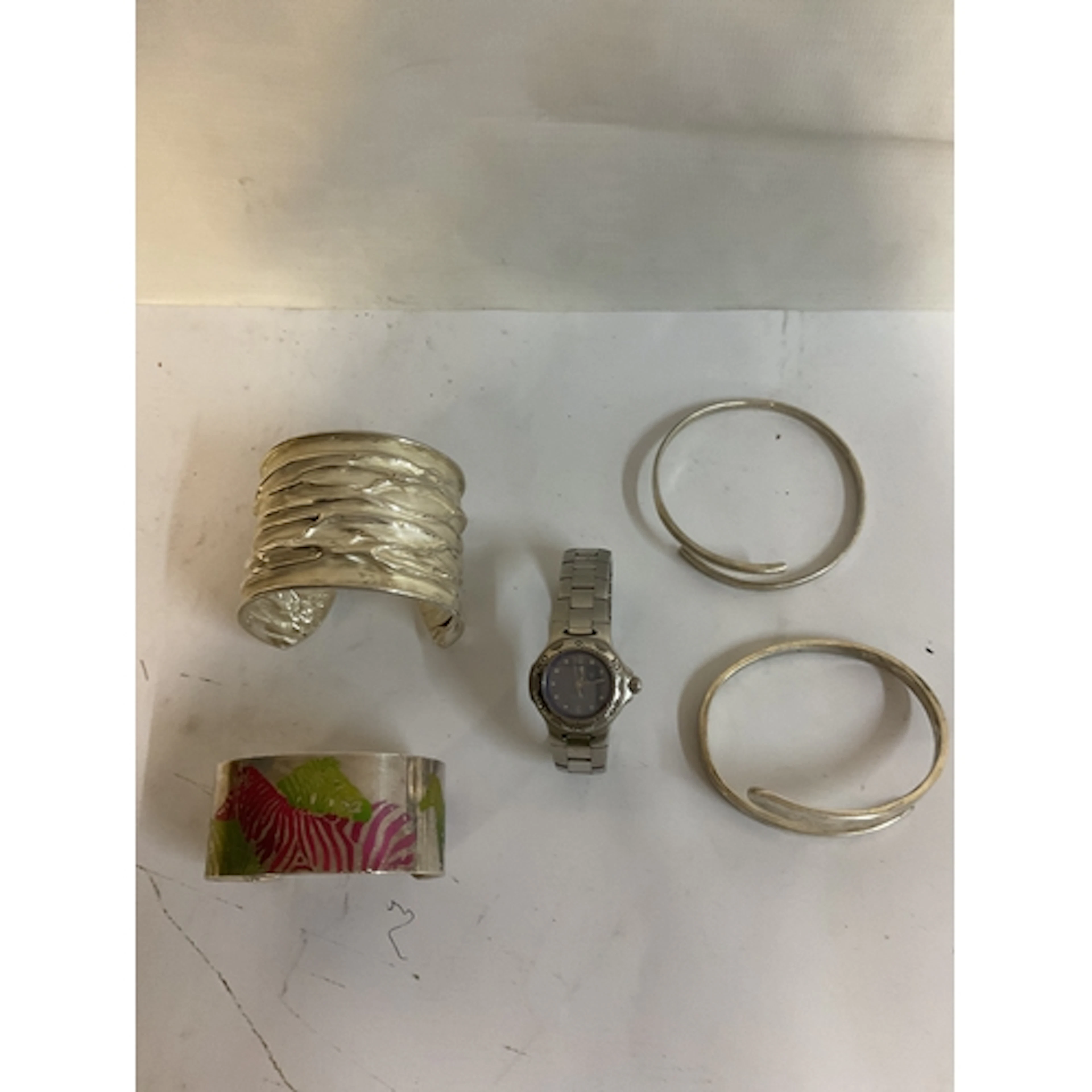 Four hallmarked silver bangles one with anodised zebras in c...