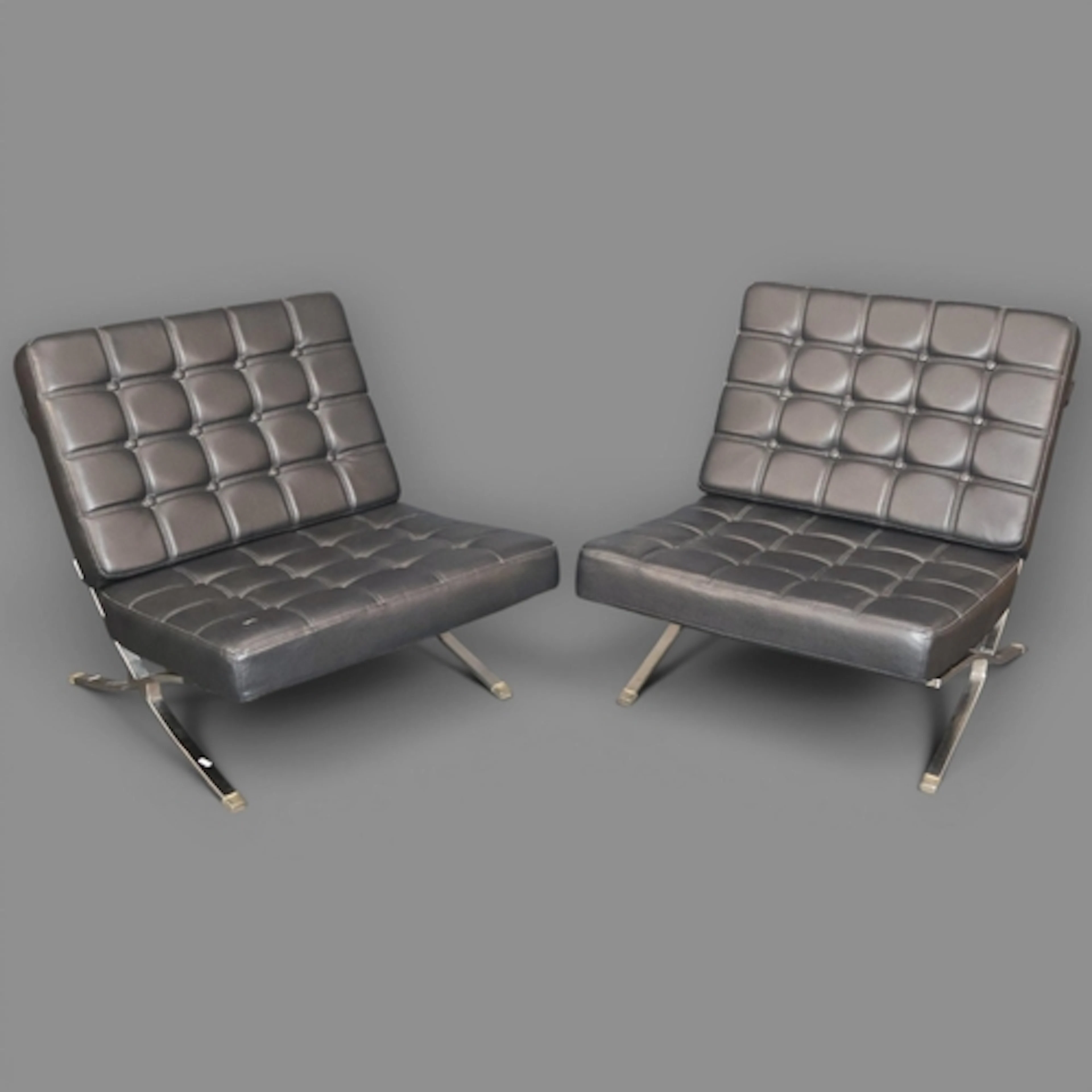 A pair of reproduction 'Barcelona Chairs by Pellissima with ...