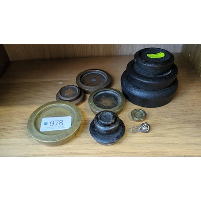 A group of balance-scale weights in brass and cast iron, of ...