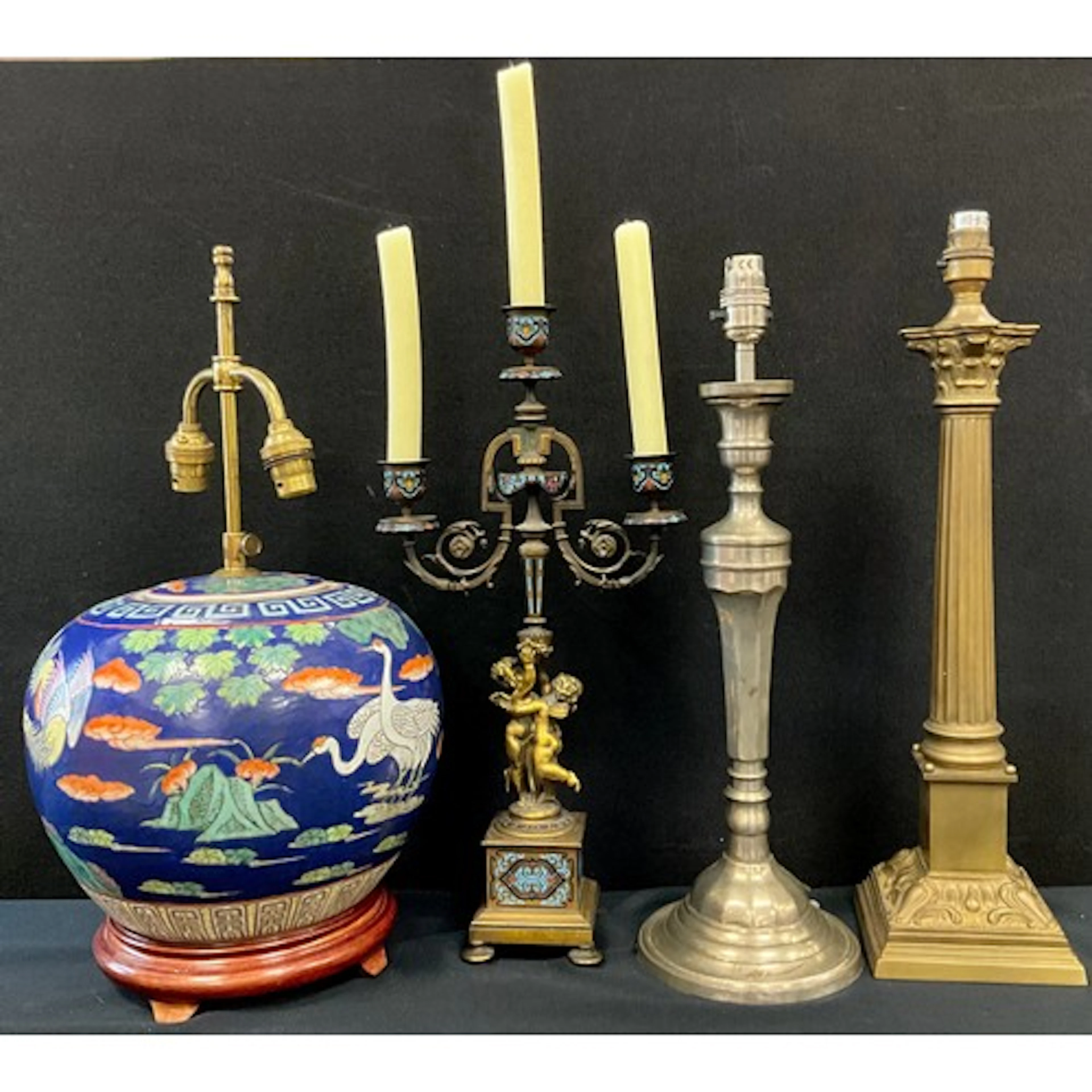 A brass and enamel three branch candelabra, scrolling foliat...