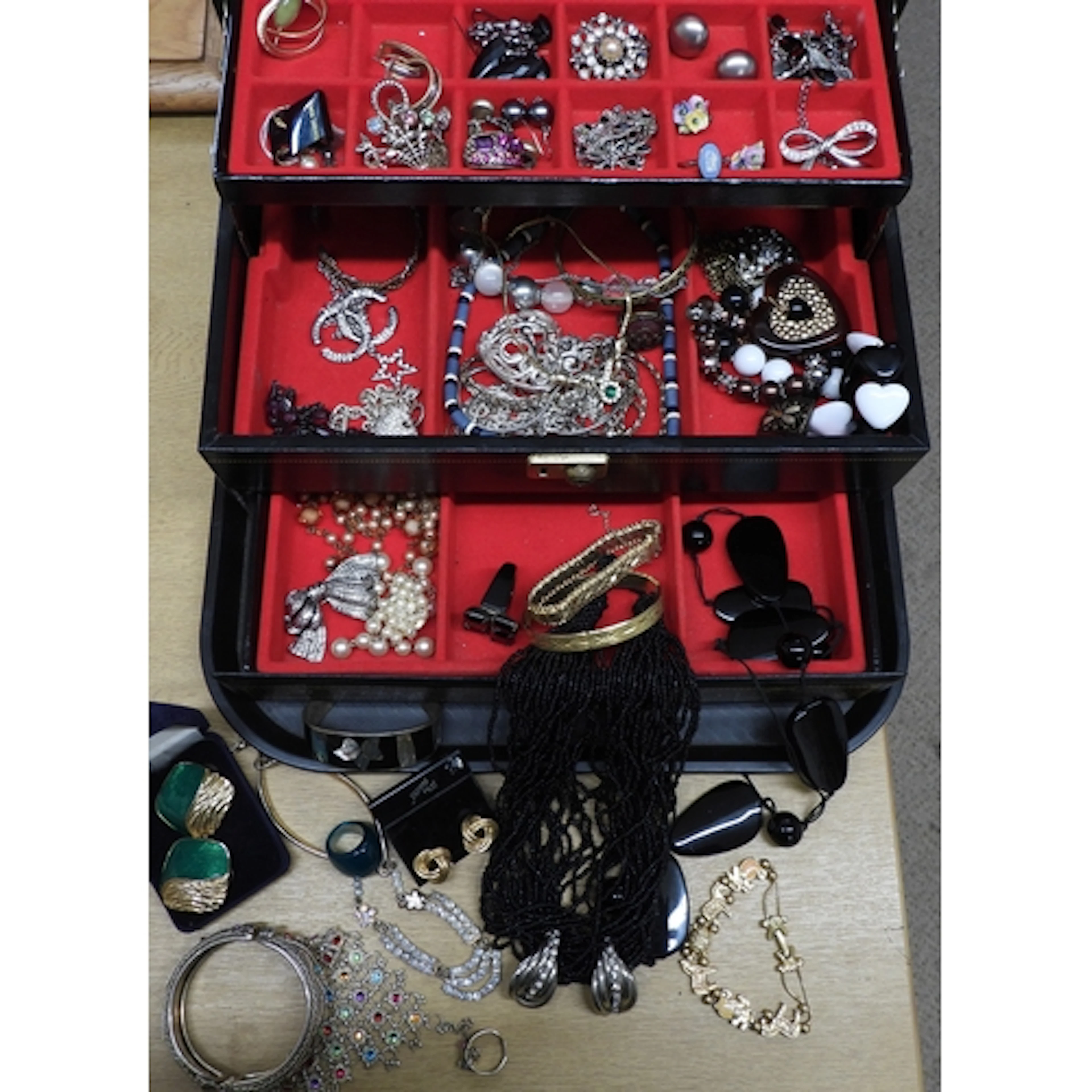 A jewellery box full of costume jewellery to include a silve...