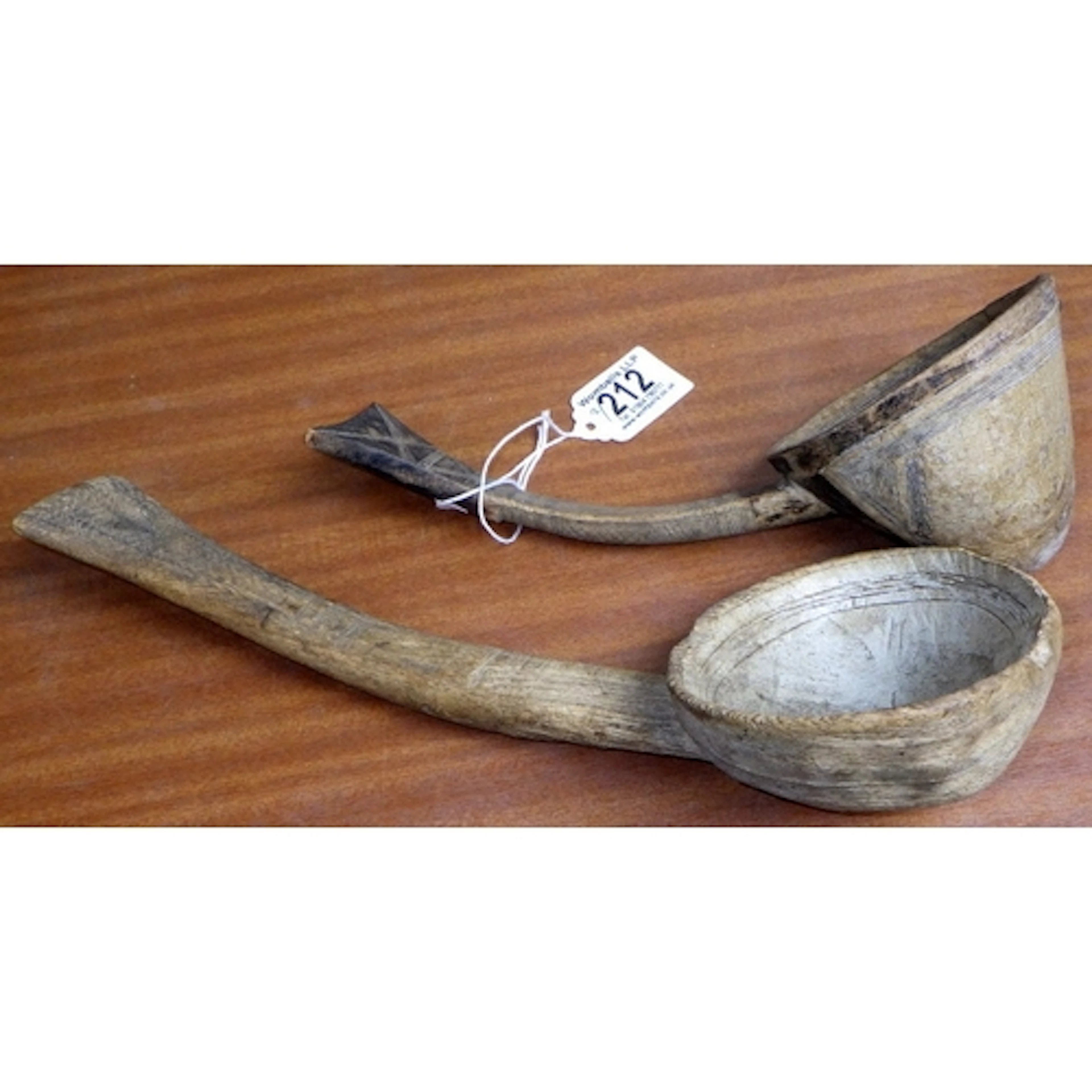 Two carved wooden ladles, purportedly from the set of Indian...