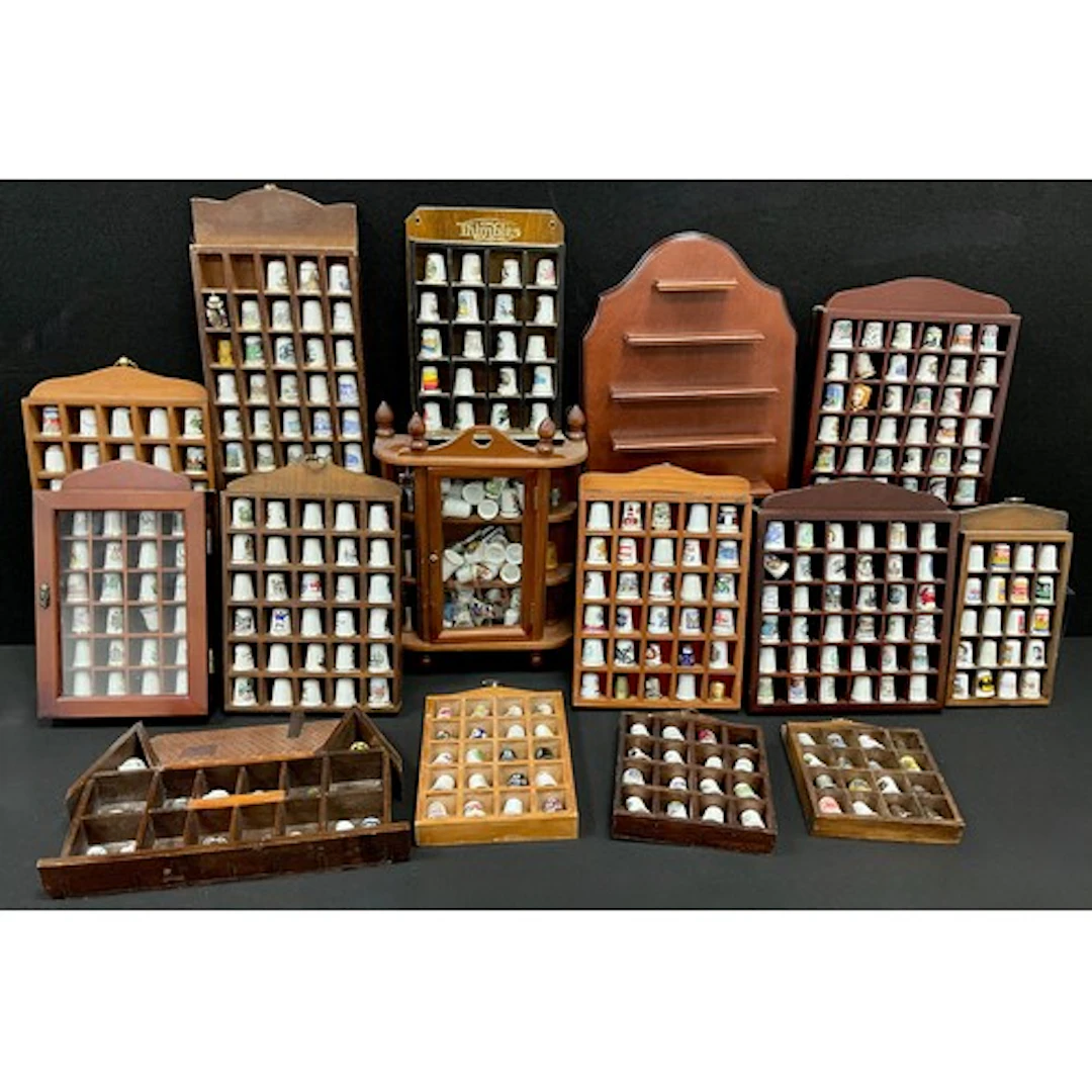 A large collection of thimbles, in thimble display cases, on...