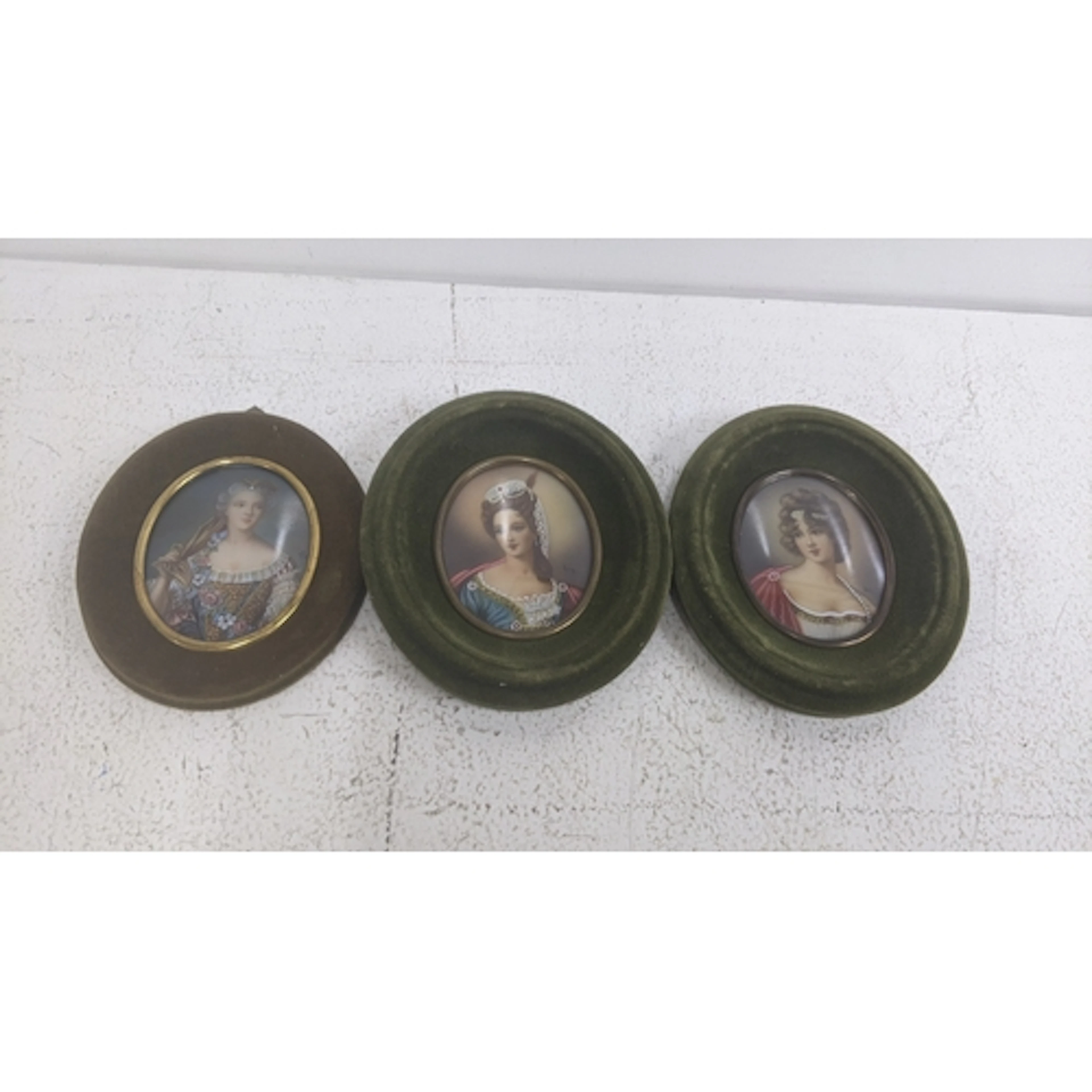 Three mid 20th century portrait miniatures to include a pair...