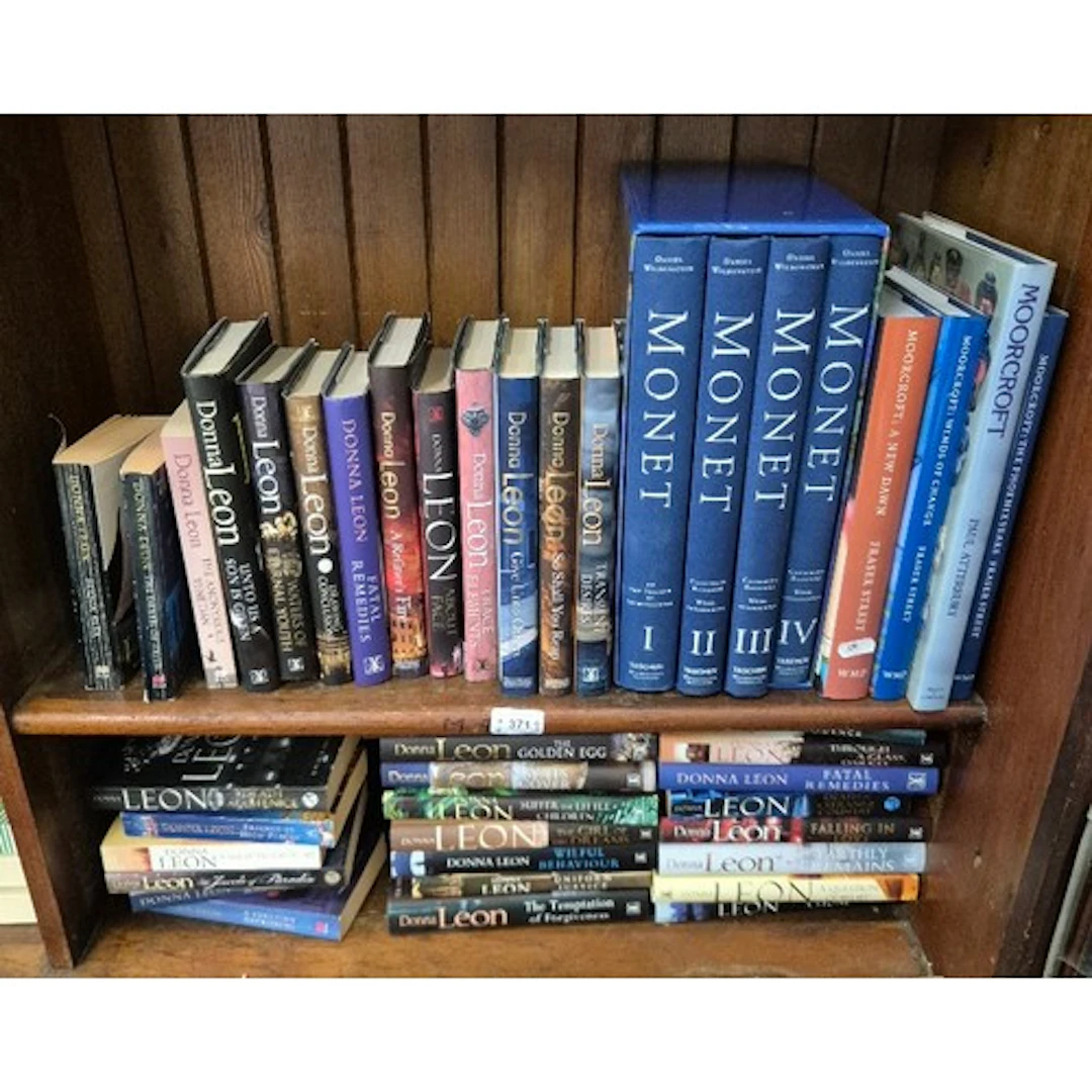 Two shelves of books, including reference books relating to ...