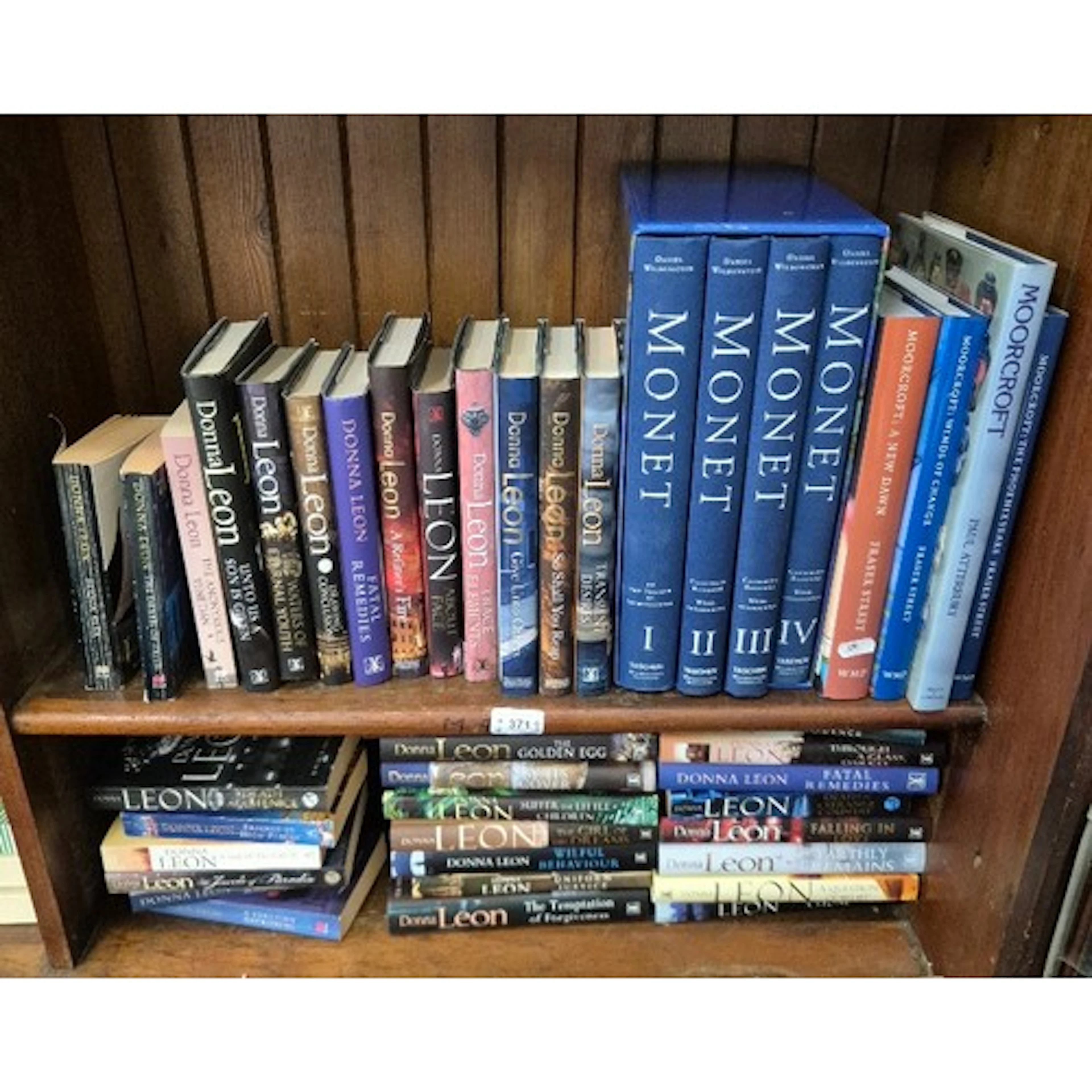 Two shelves of books, including reference books relating to ...