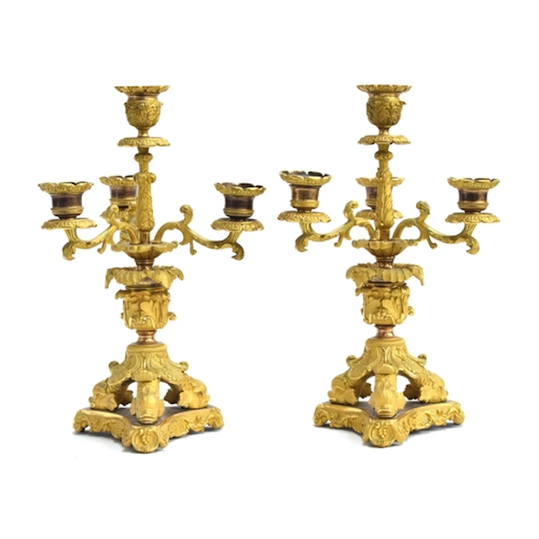 A pair of French gilt bronze four fitting candlesticks, 19th...