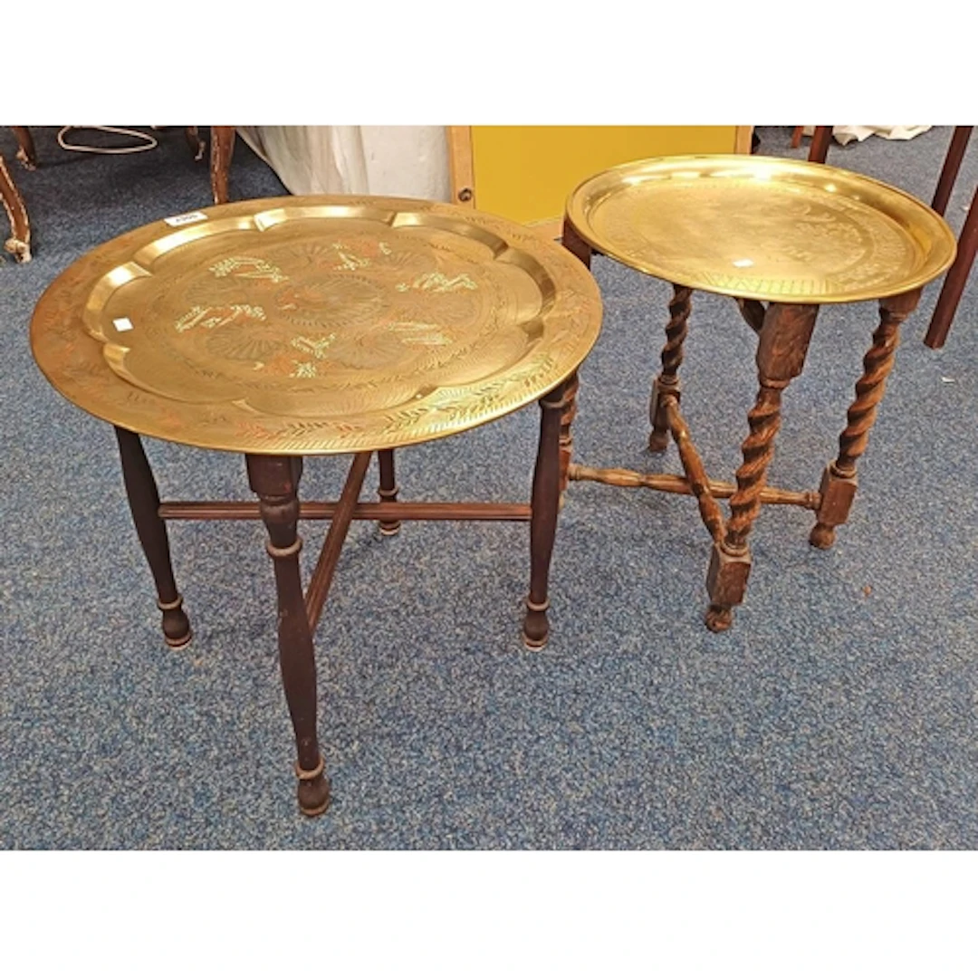 2 EASTERN BRASS TRAY TABLES WITH ETCHED DECORATION ON FOLDIN...