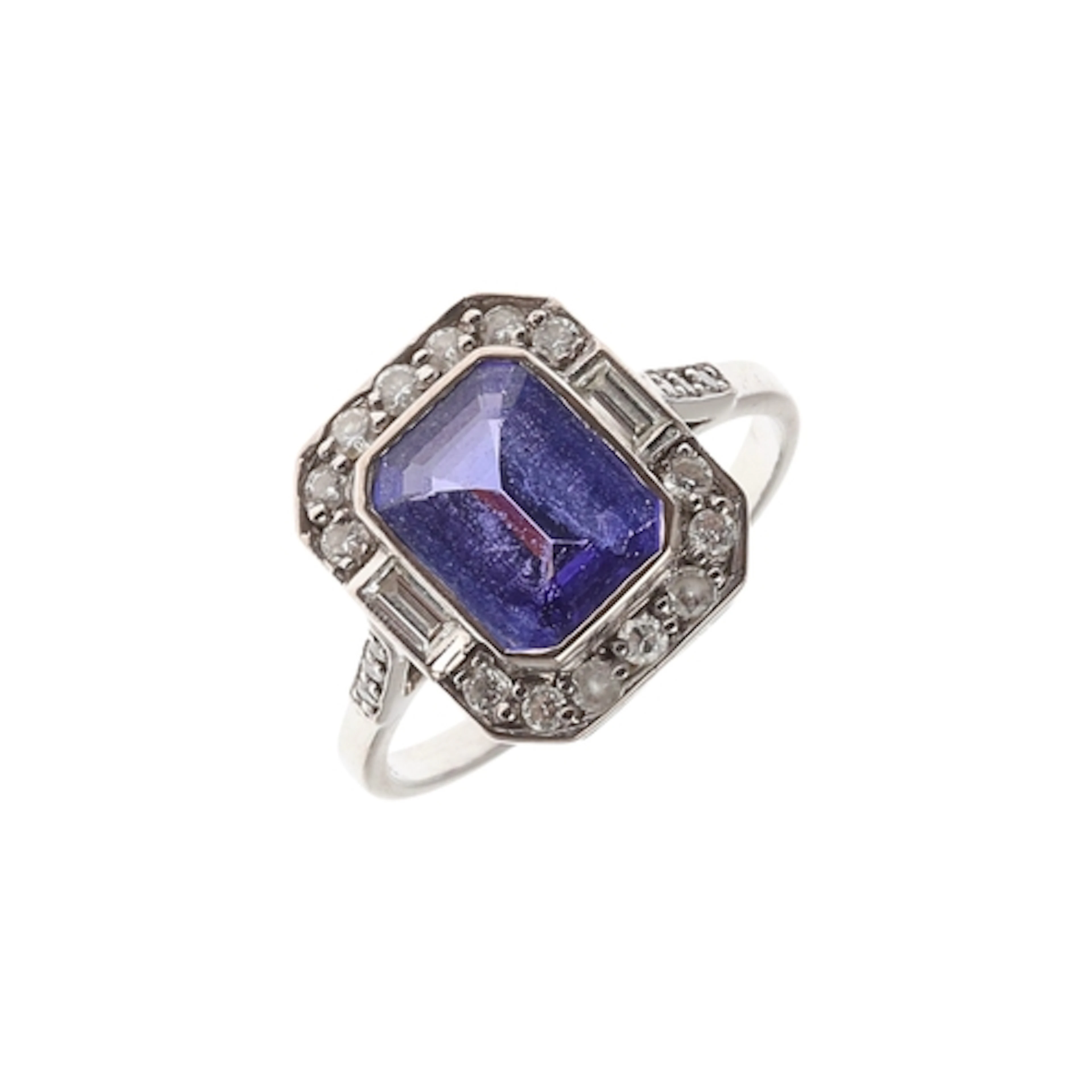 A TANZANITE AND DIAMOND CLUSTER RING. the step-cut tanzanite...