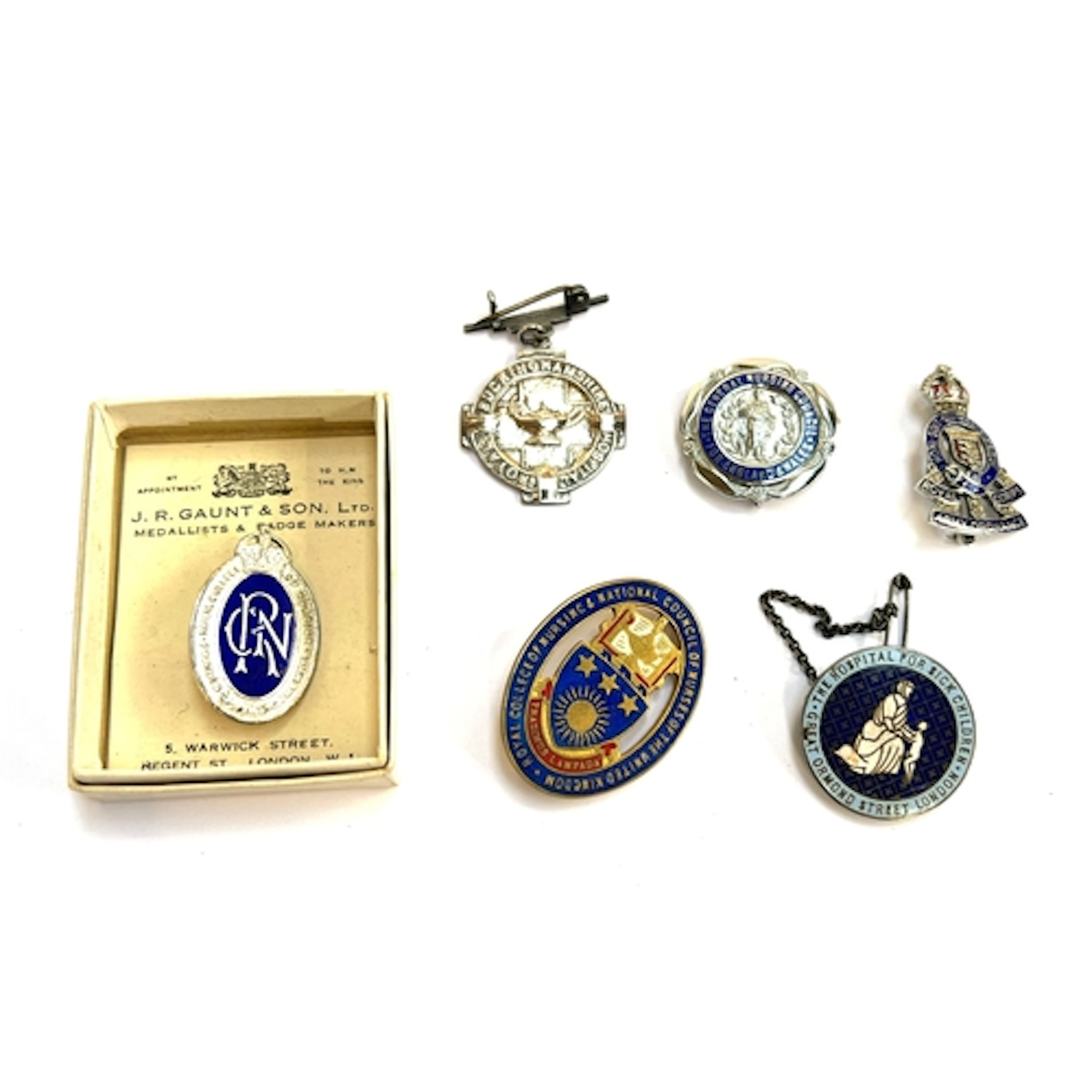 Three silver and enamel badges for the Royal College of Nurs...