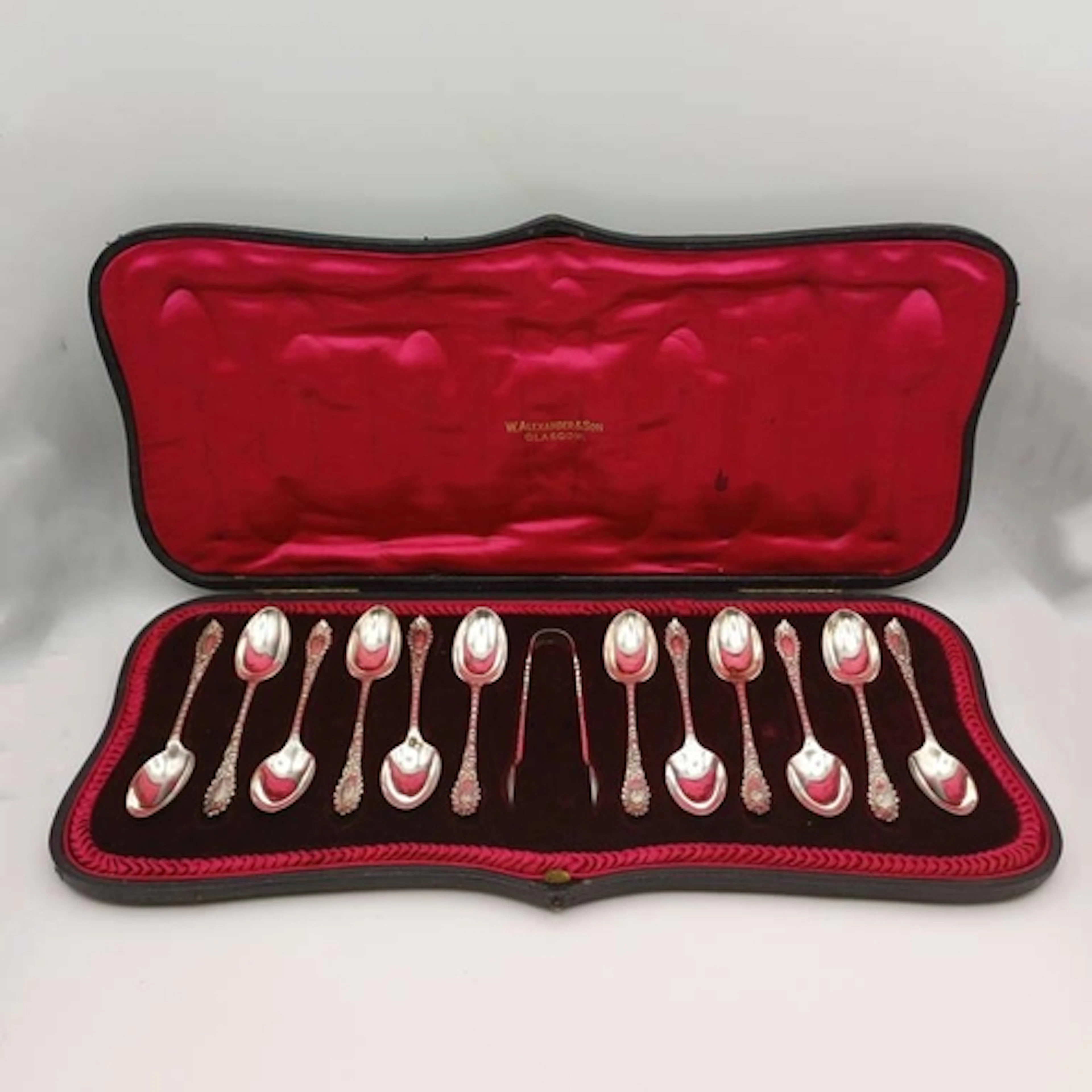 A CASED SET OF 12 SILVER COFFEE SPOONS & SUGAR TONGS BY JOSI...