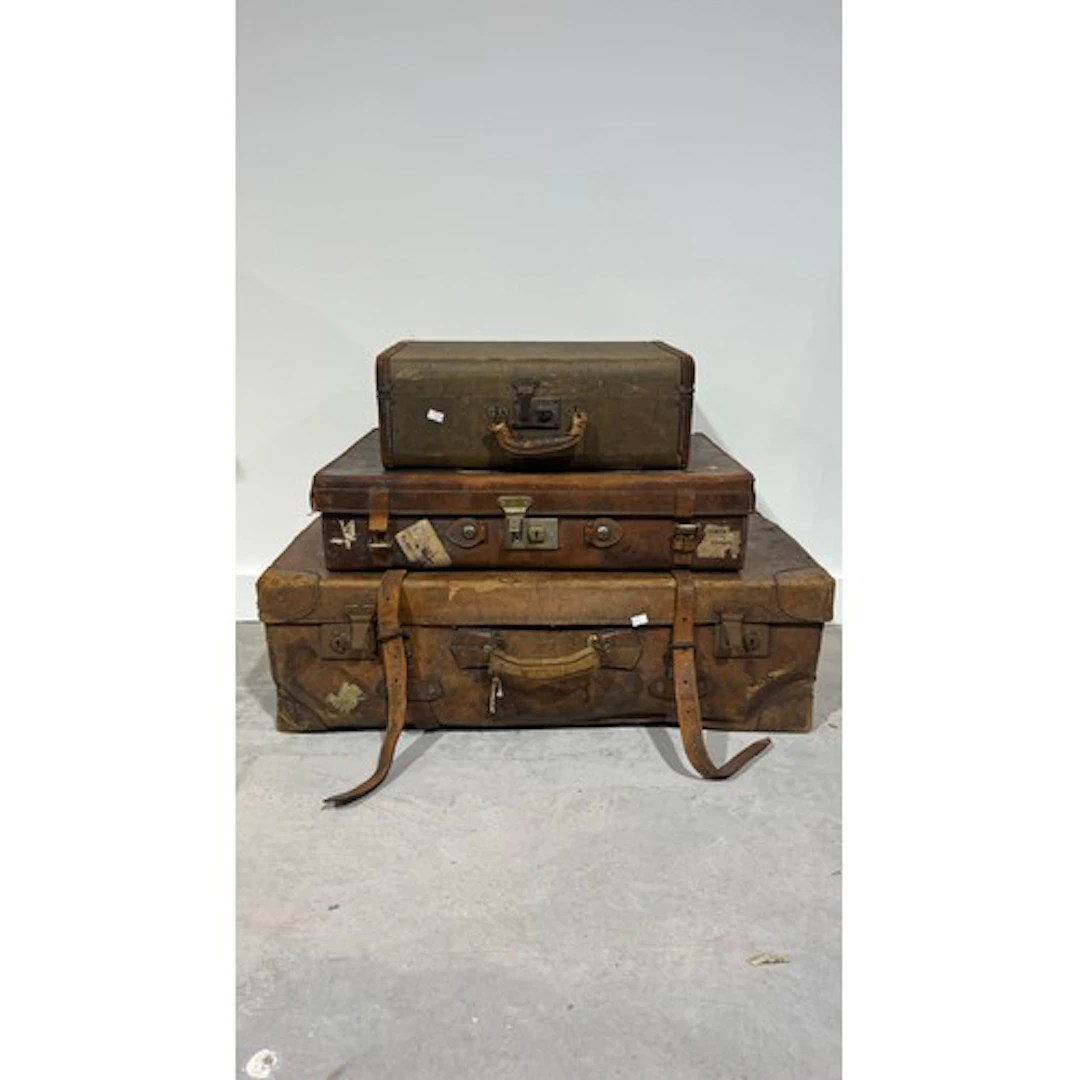 Three vintage suitcases comprising two leather, and another....