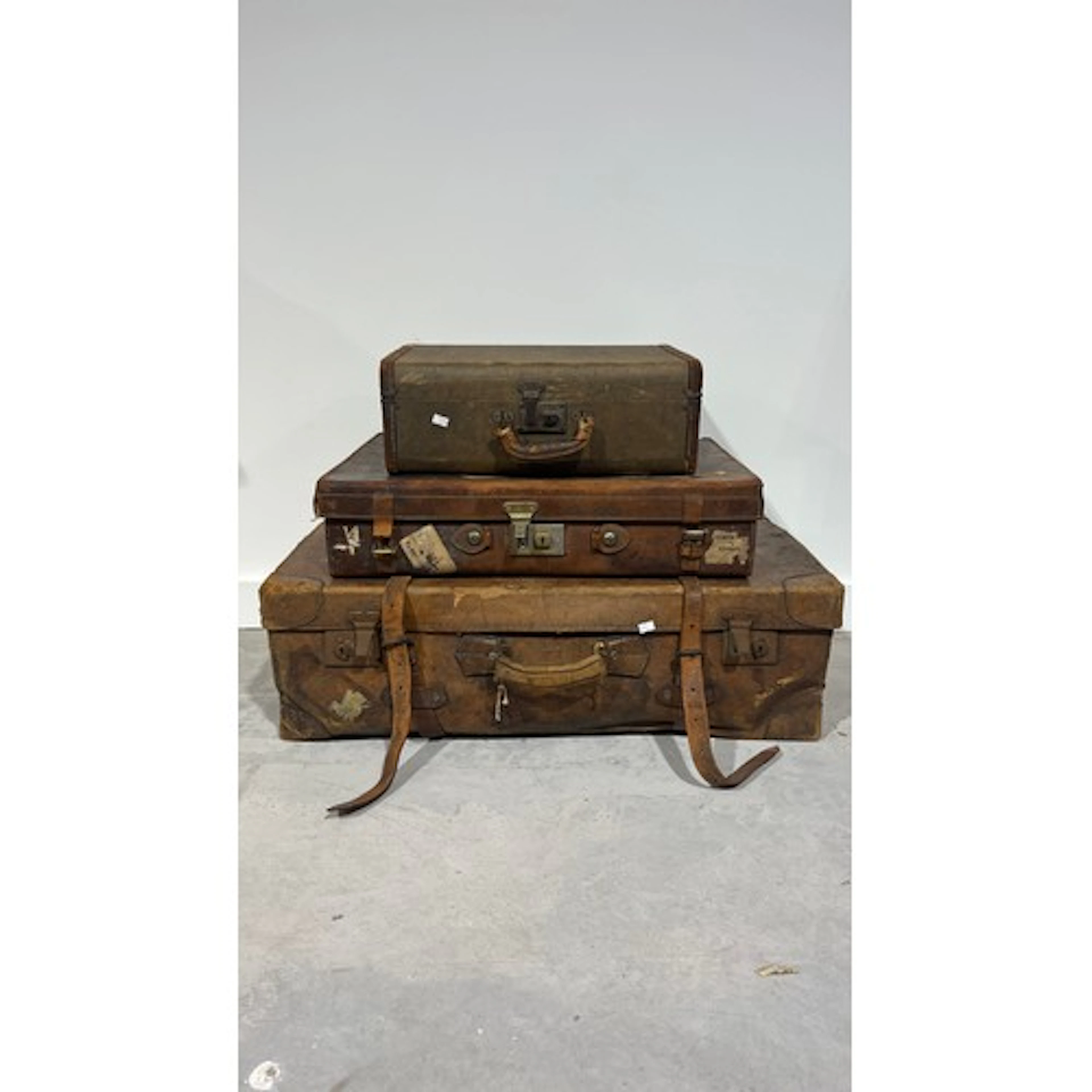 Three vintage suitcases comprising two leather, and another....