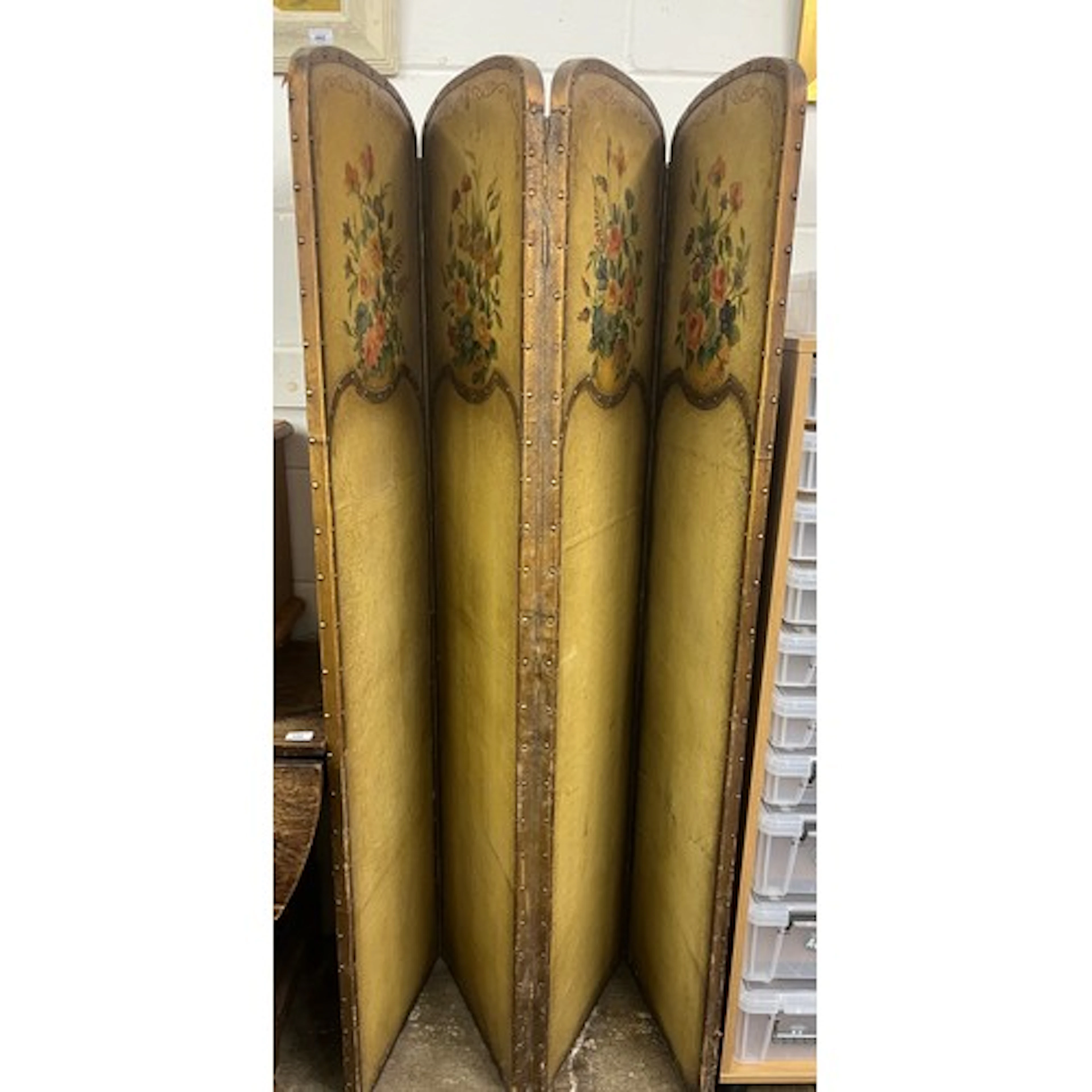 Cream and painted four fold screen decorated with flowers.