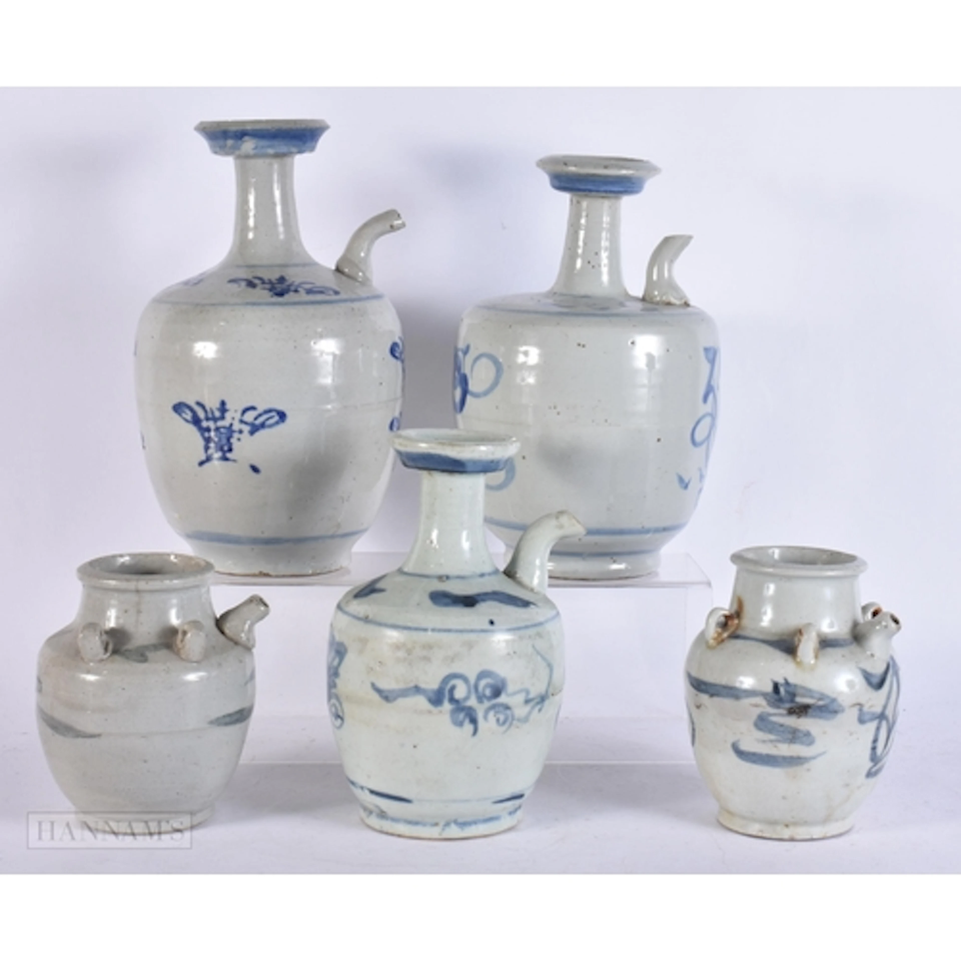 FIVE 17TH/18TH CENTURY CHINESE BLUE AND WHITE KENDI EWERS M...