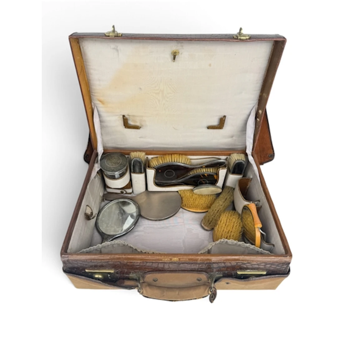 A SILVER AND TORTOISESHELL VANITY SET IN LEATHER CASE ...