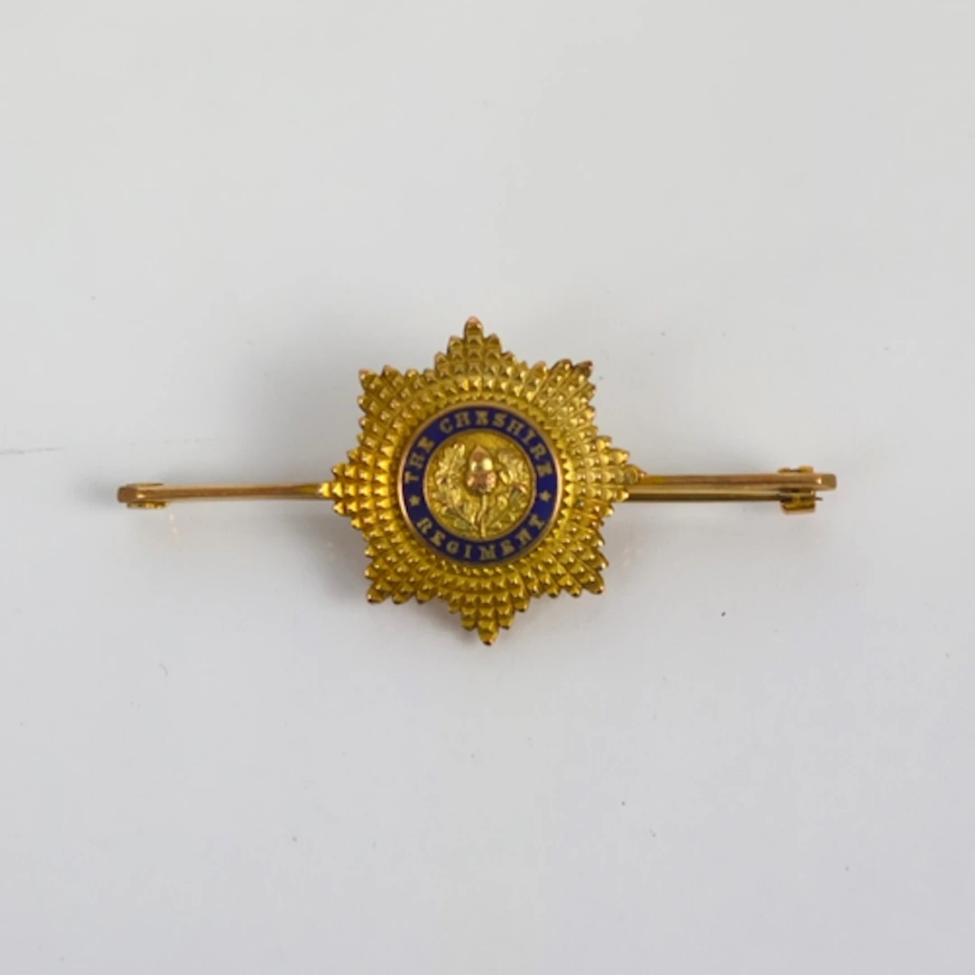 An early 20th century yellow metal ‘The Cheshire Regiment’ b...
