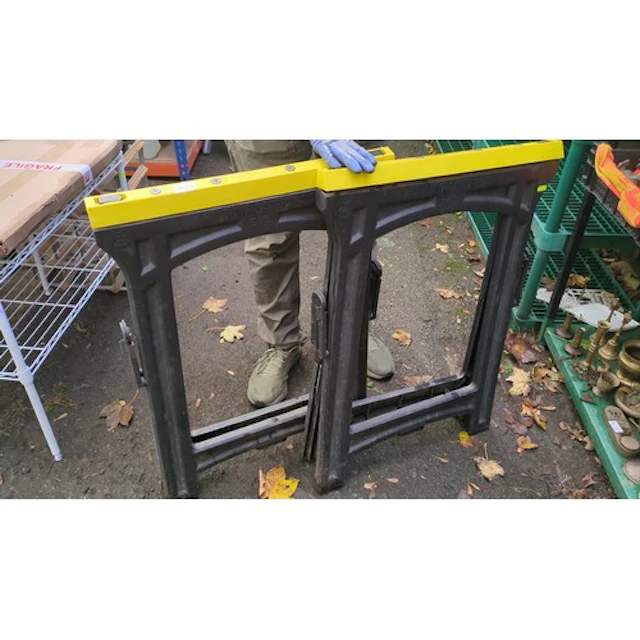 A pair of folding moulded-plastic sawhorses with yellow grad...