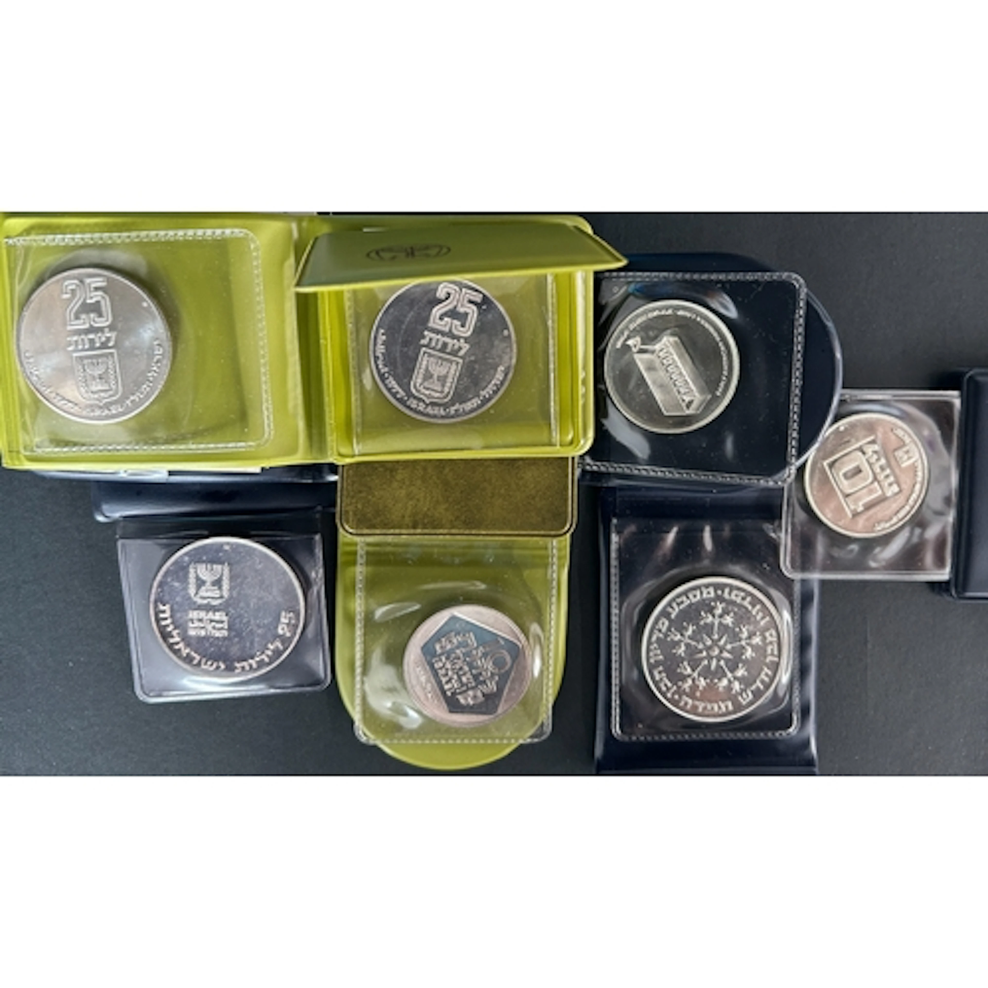 A group of seven Israeli silver commemorative medallions, is...