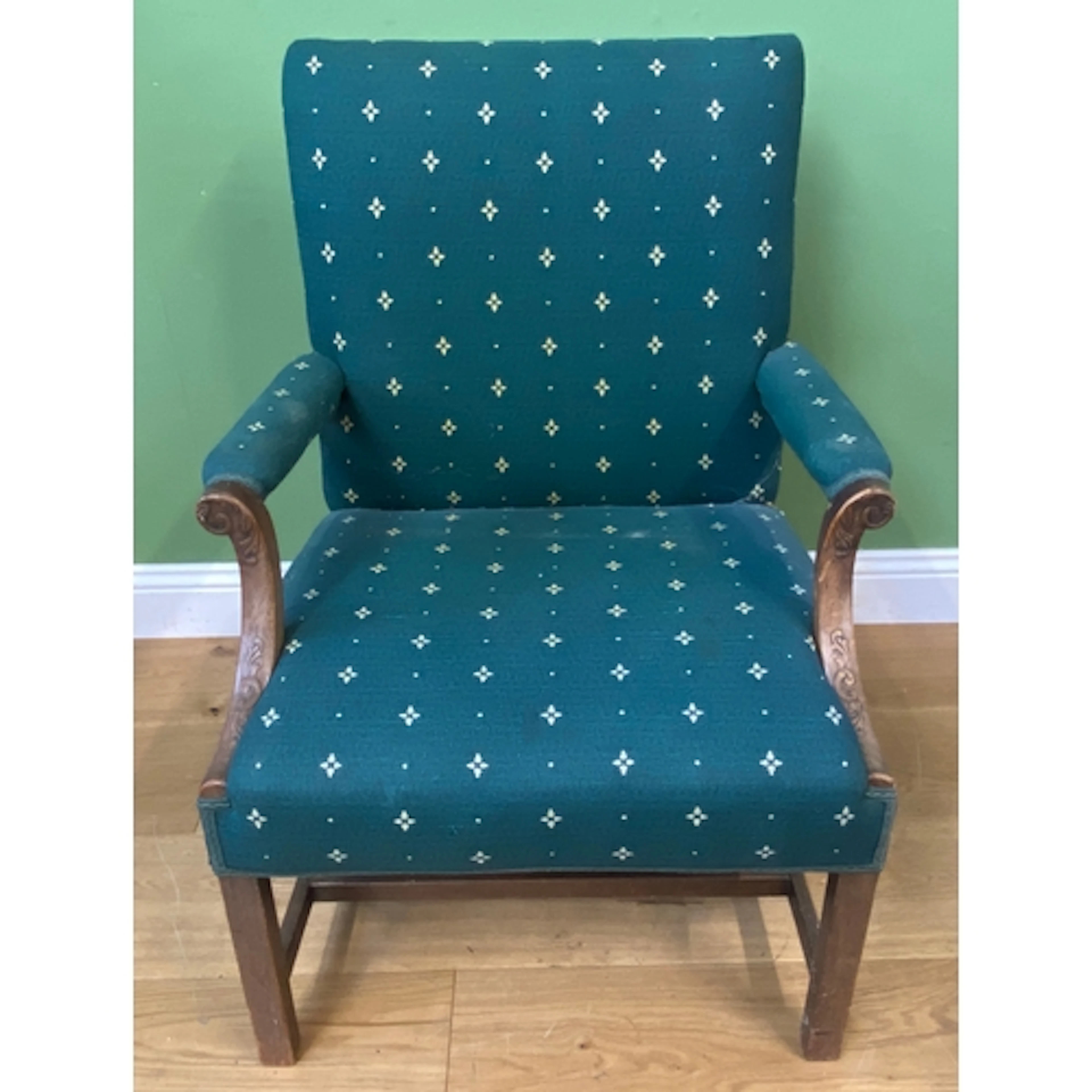 A George III mahogany and upholstered open armchair with car...