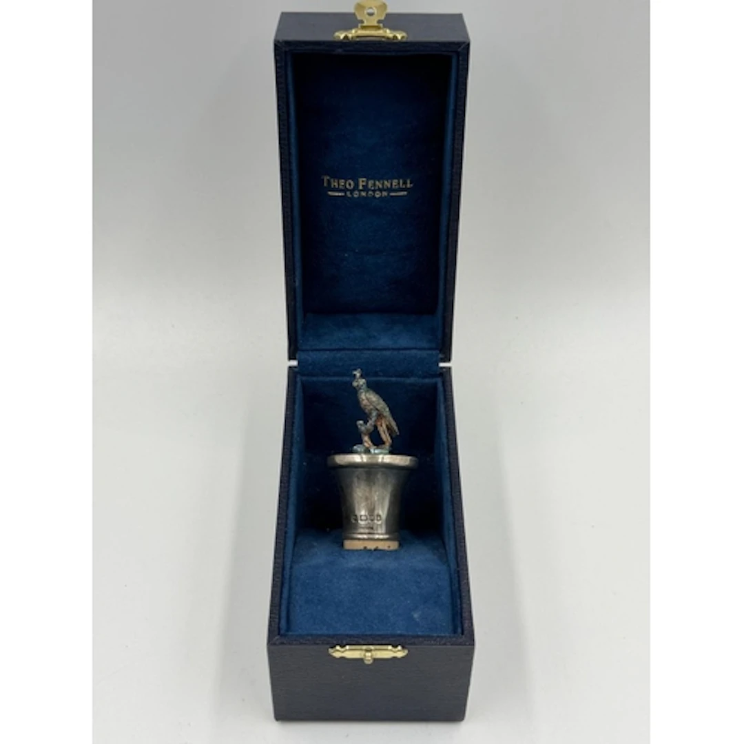 A Theo Fennell hallmarked silver falcon figural wine bottle ...