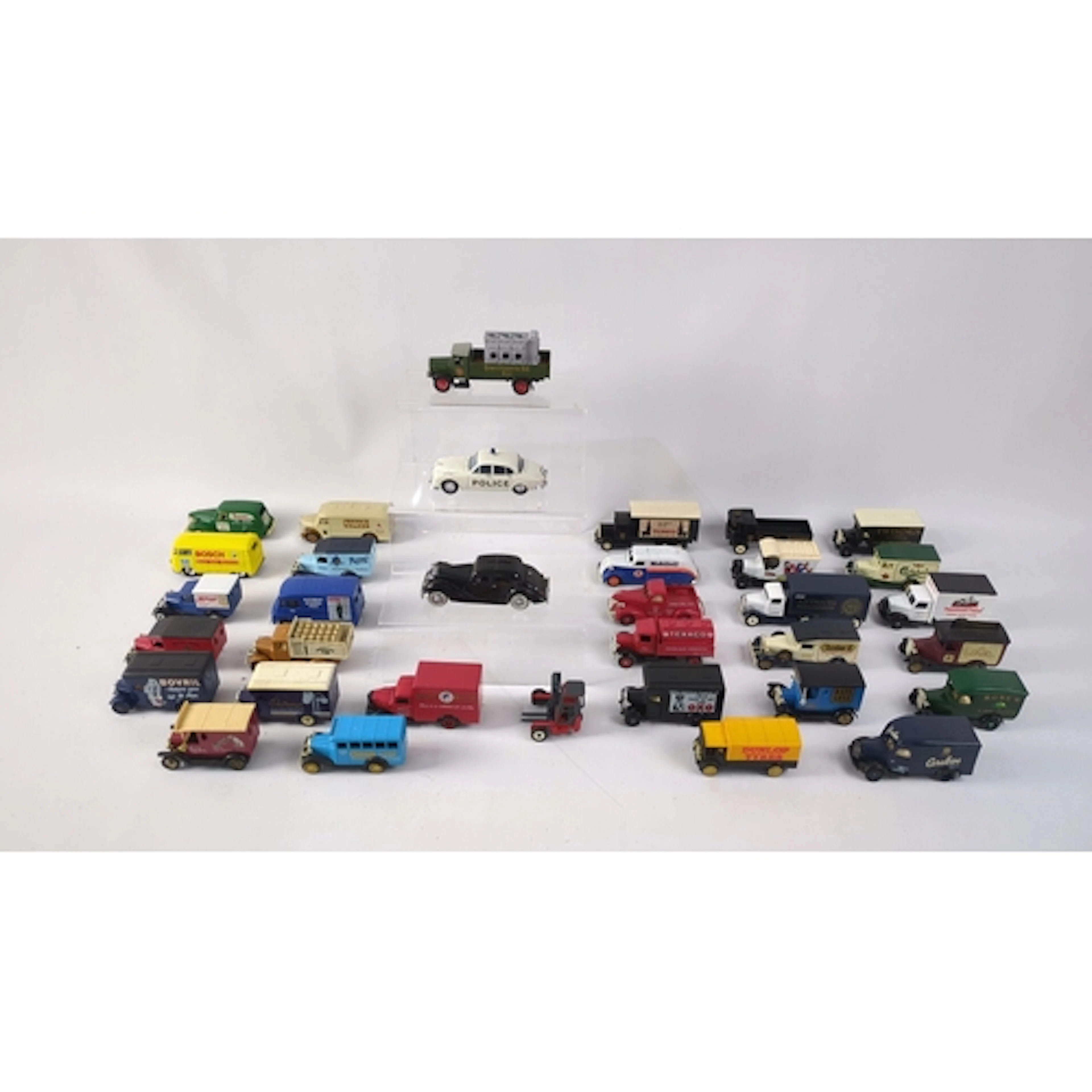 A group of die-cast model delivery vans and commercial vehic...