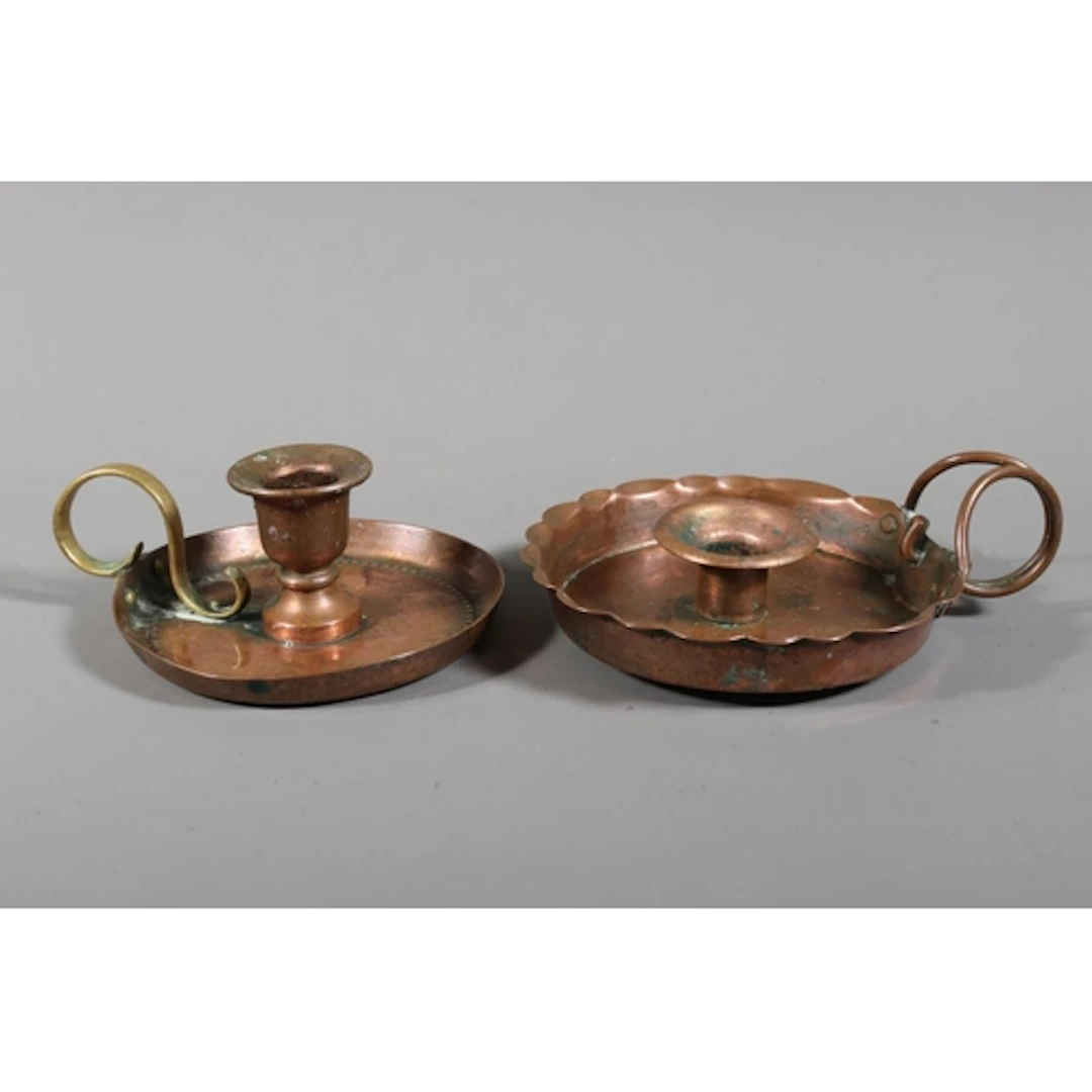 Two copper Arts & Crafts candle holders with drip trays,...