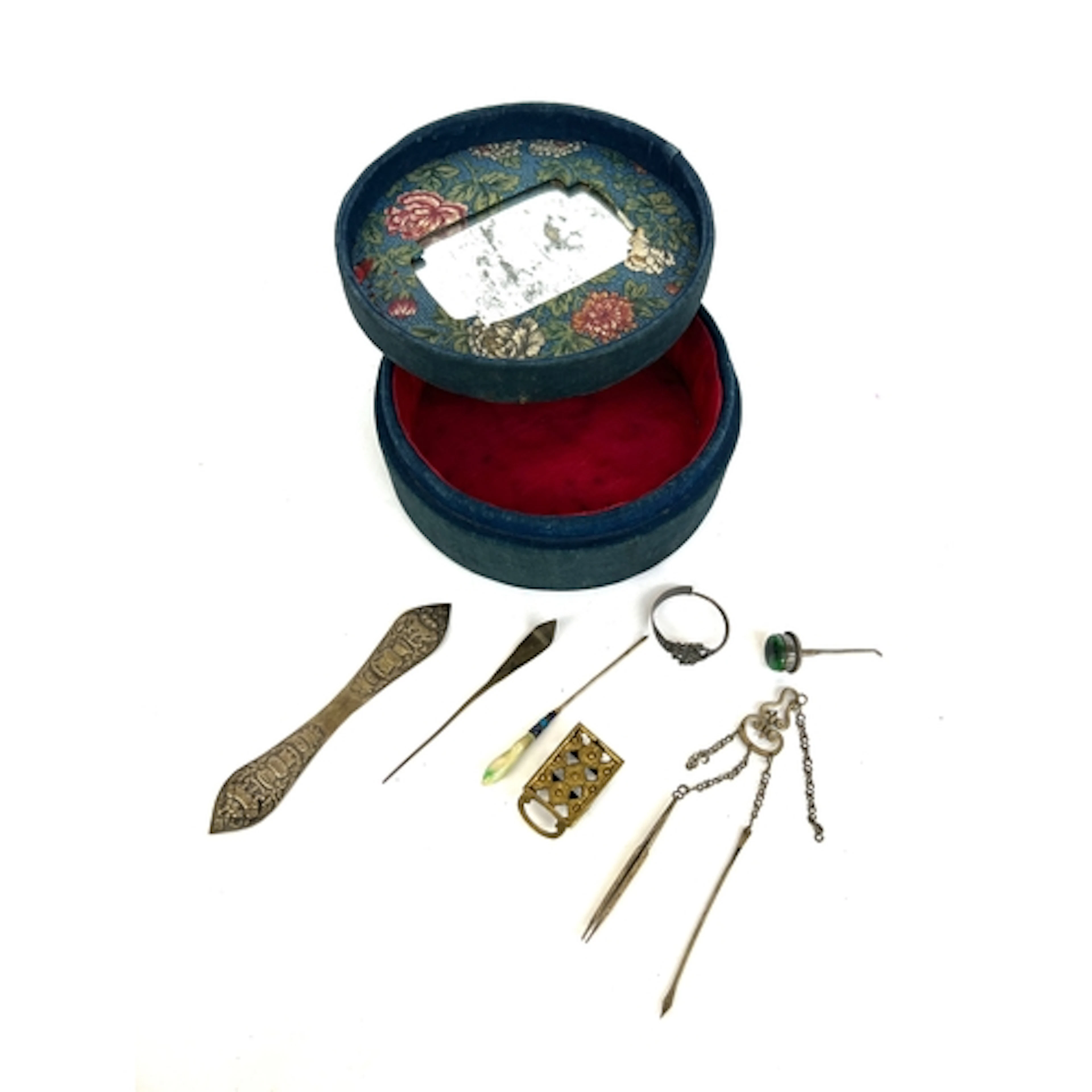 A Chinese velvet circular box containing a small quantity of...