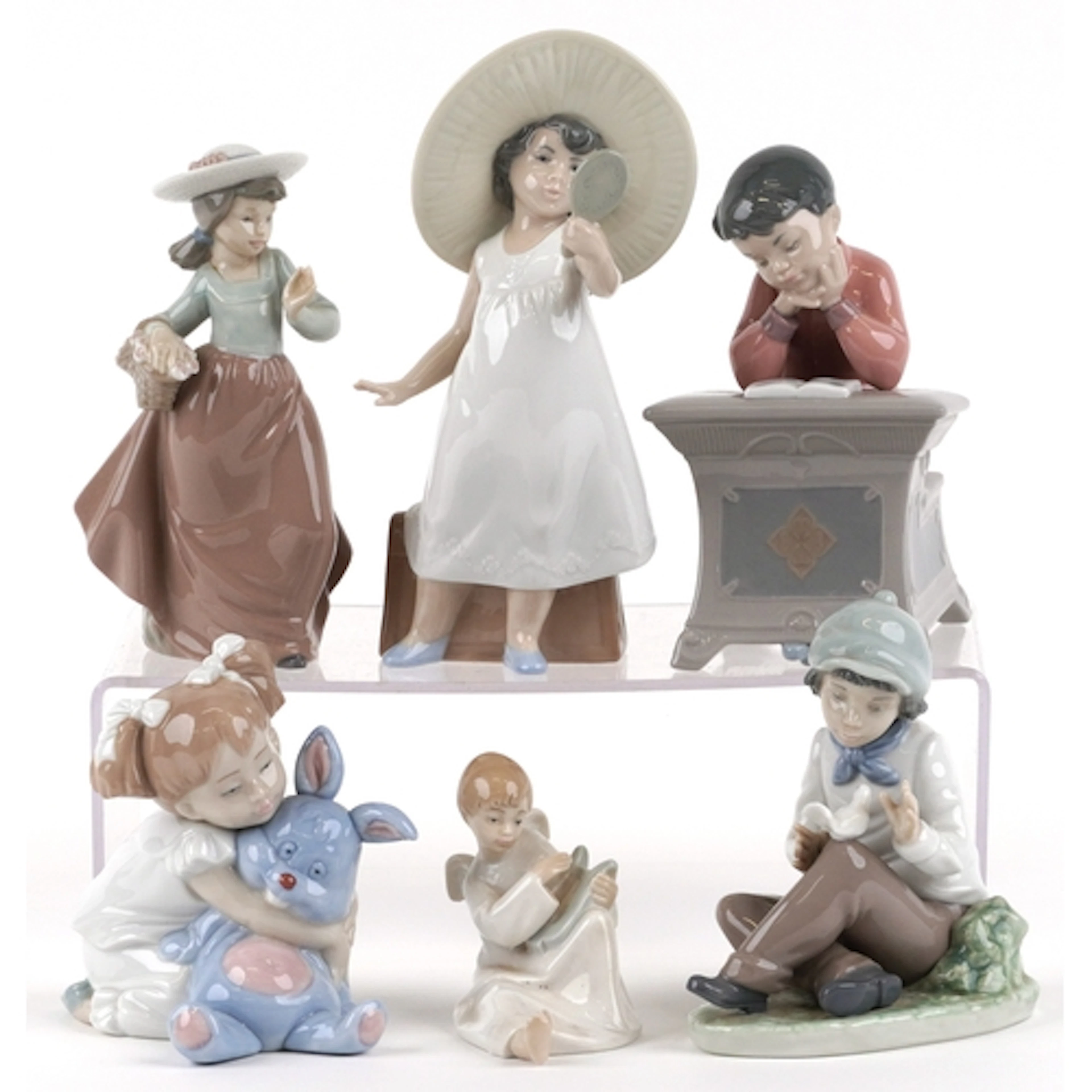 Six Nao porcelain figures of young children including a boy ...