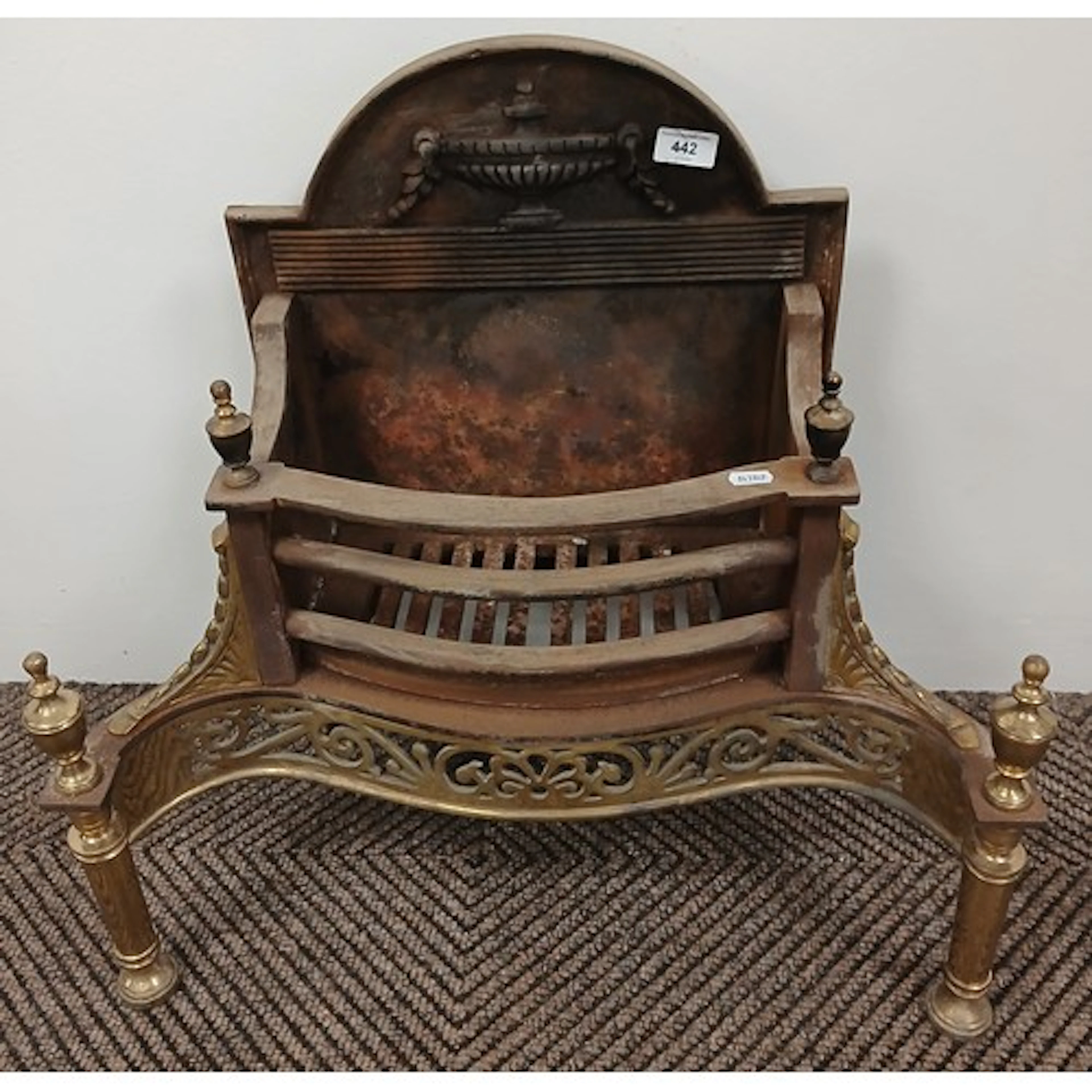 Adam style cast iron and brass fire basket.