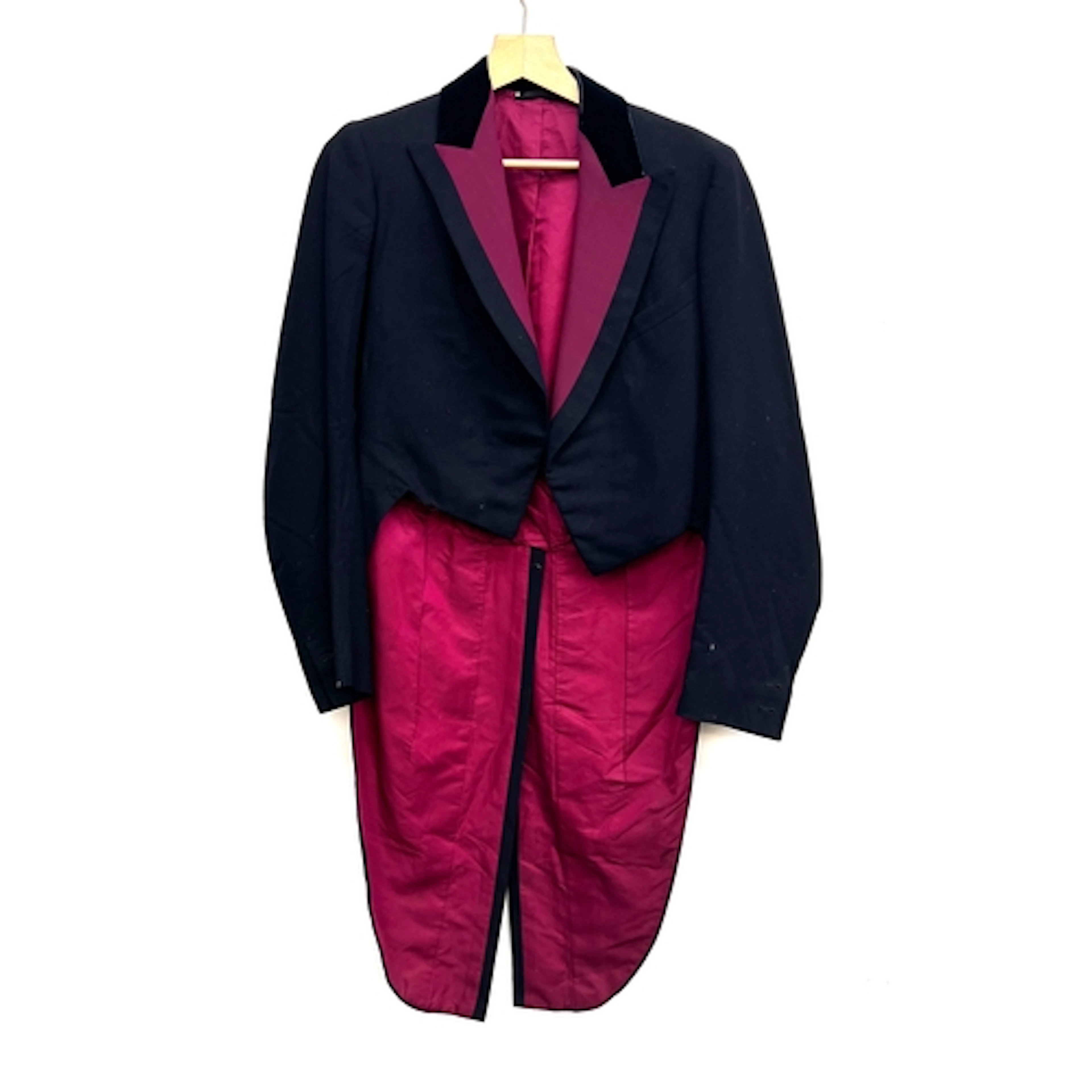 A pair of black evening tails with burgundy corded silk faci...