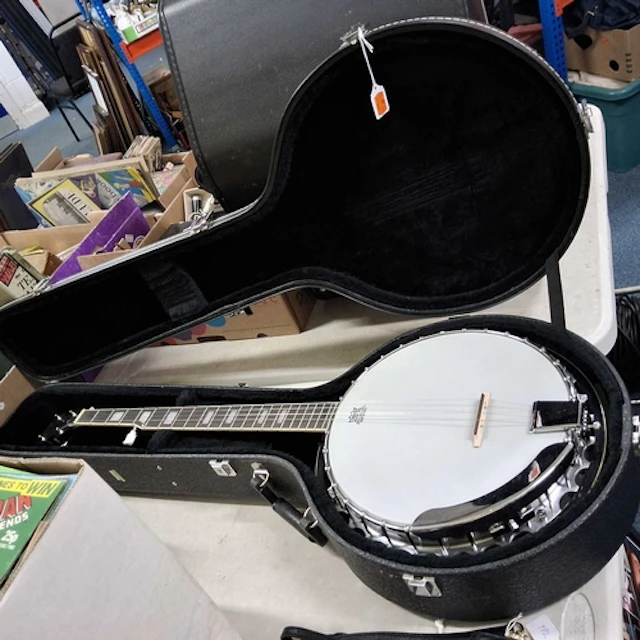 A FLEETWOOD RESONATOR BANJO AND HARD CASE, featuring a white...