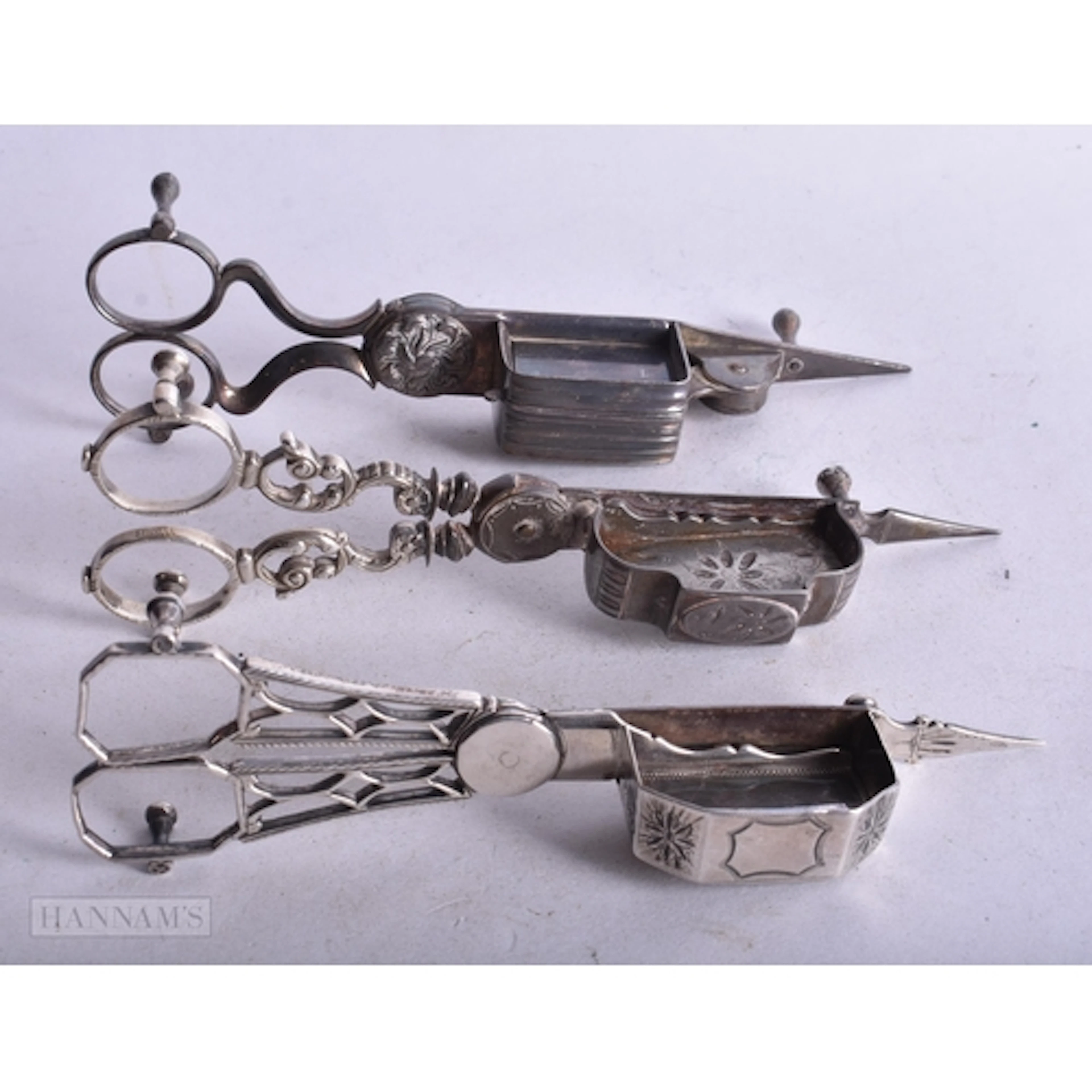 A PAIR OF George III SILVER CANDLE SNUFFERS together with tw...