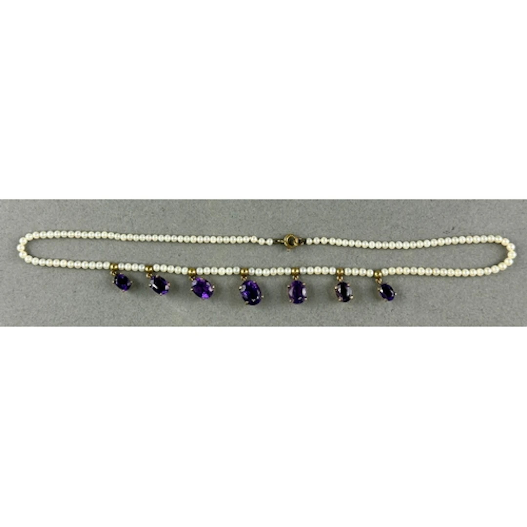 Jewellery: a 9ct gold mounted seed pearl necklace, with seve...